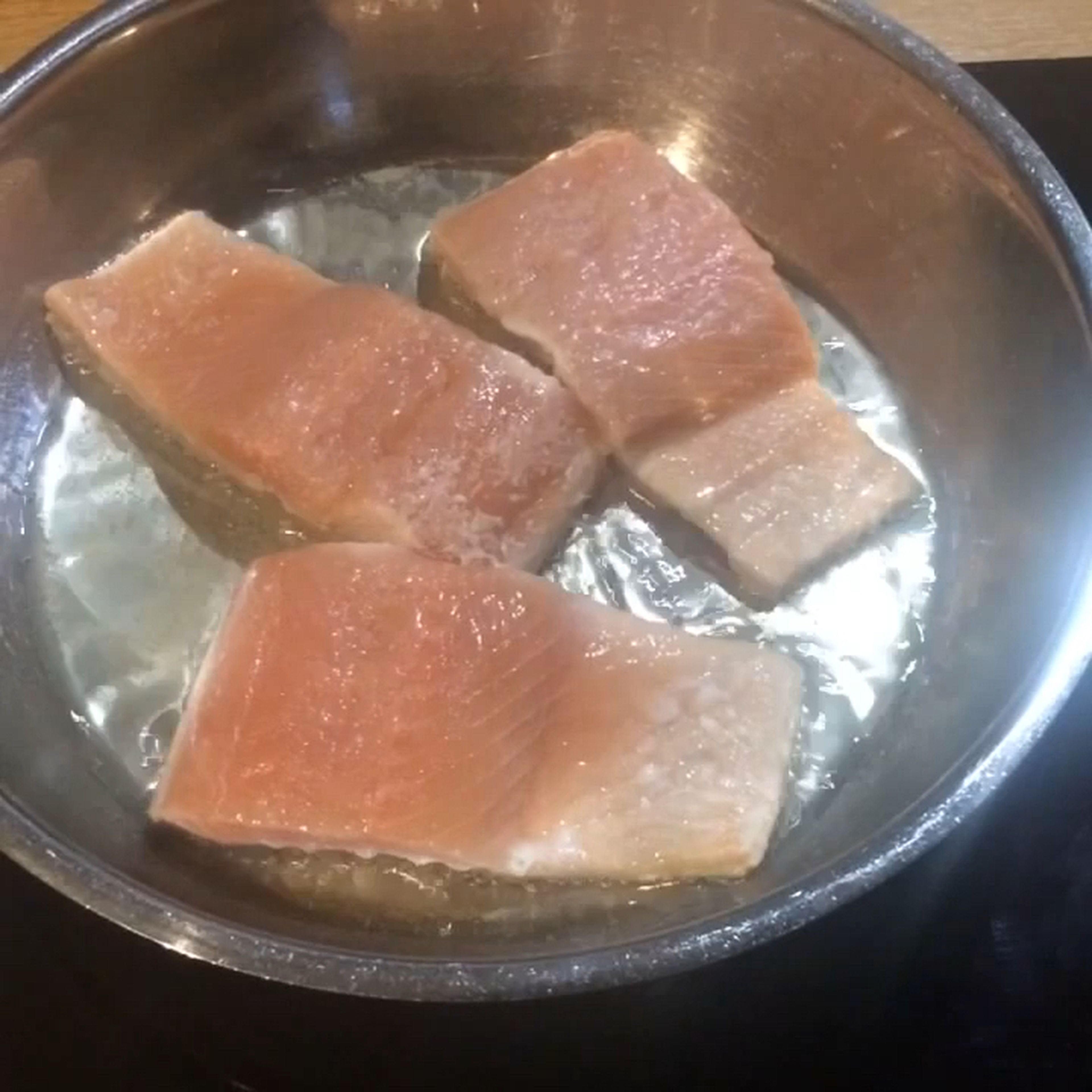 Pour oil in skillet and preheat to medium-high heat before adding salmon. Lower the heat slightly after 1 minute