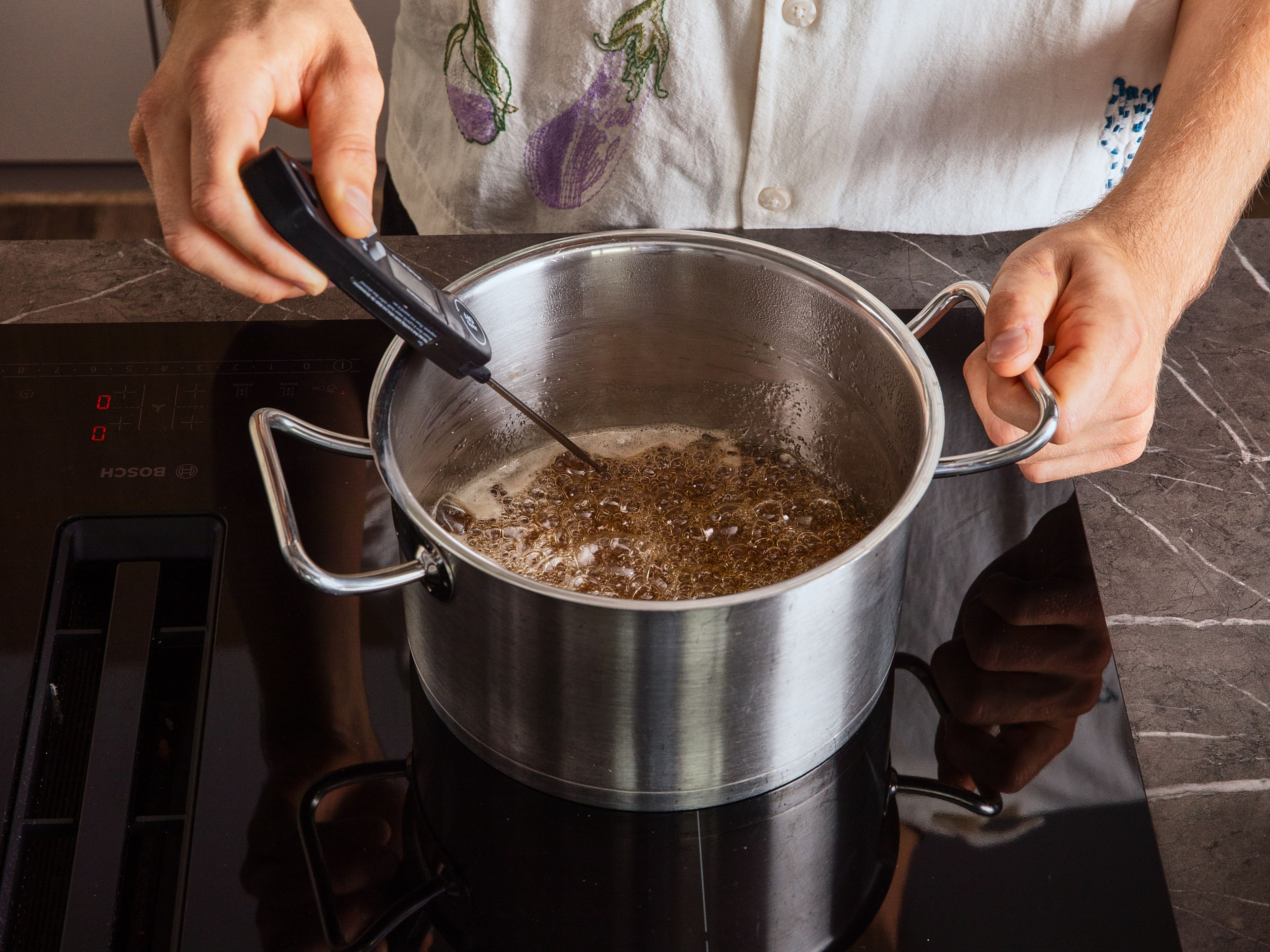 Add sugar, honey, and water to a saucepan and heat everything over medium-high heat, stirring constantly. Keep stirring until sugar is dissolved and the mixture starts to boil. Stop stirring and check the temperature with a thermometer. Make sure that the tip of the thermometer only touches the liquid and not the bottom of the saucepan.