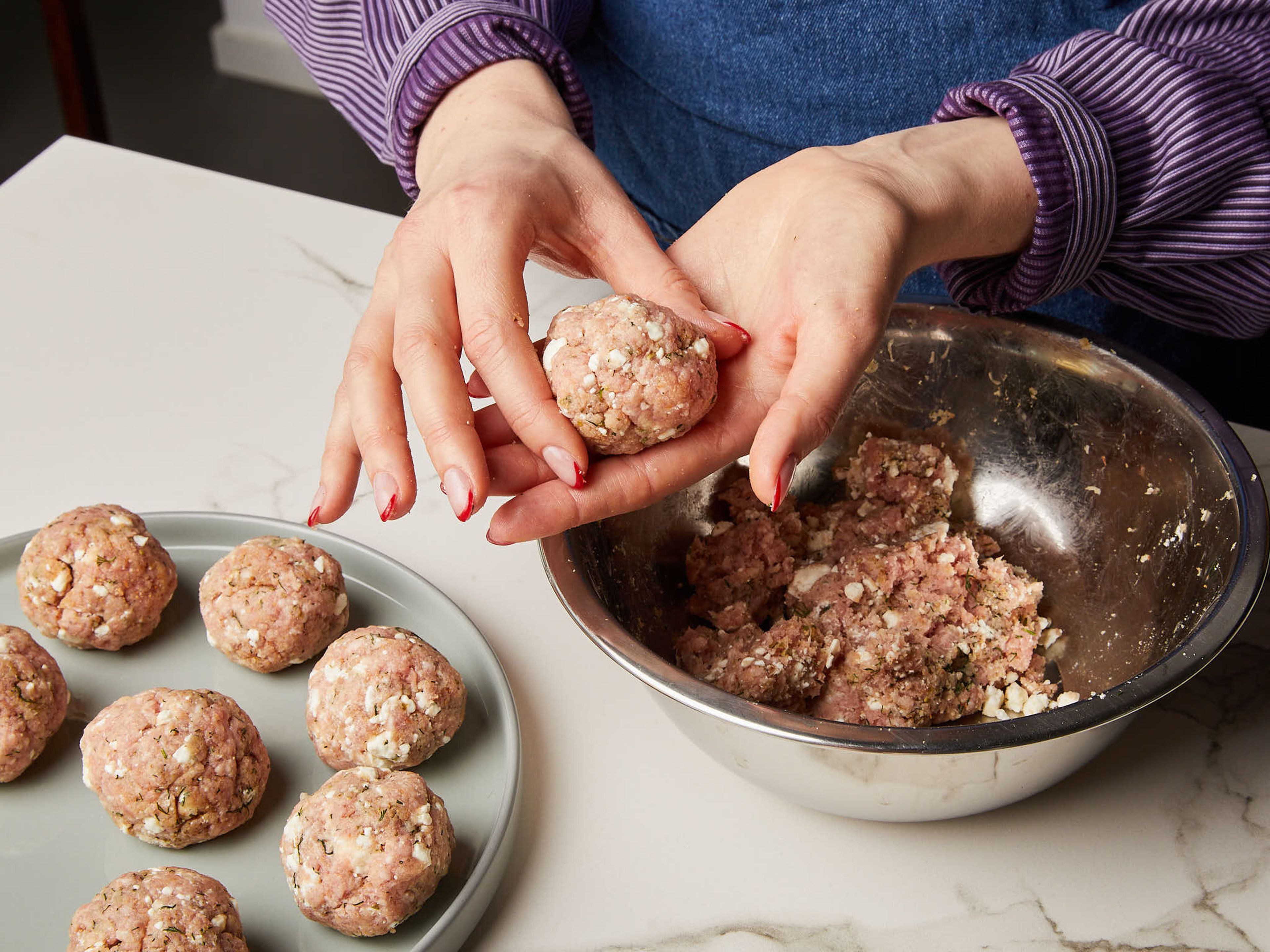 Finely grate garlic and chop dill. Zest and juice half your lemons and set aside. In a bowl, gently mix pork mince, ⅔ of feta, garlic, breadcrumbs, egg, oregano, cumin, ground coriander seeds, ½ of the dill, salt, and pepper. With clean, wet hands, roll mix into approx. golf ball size meatballs.