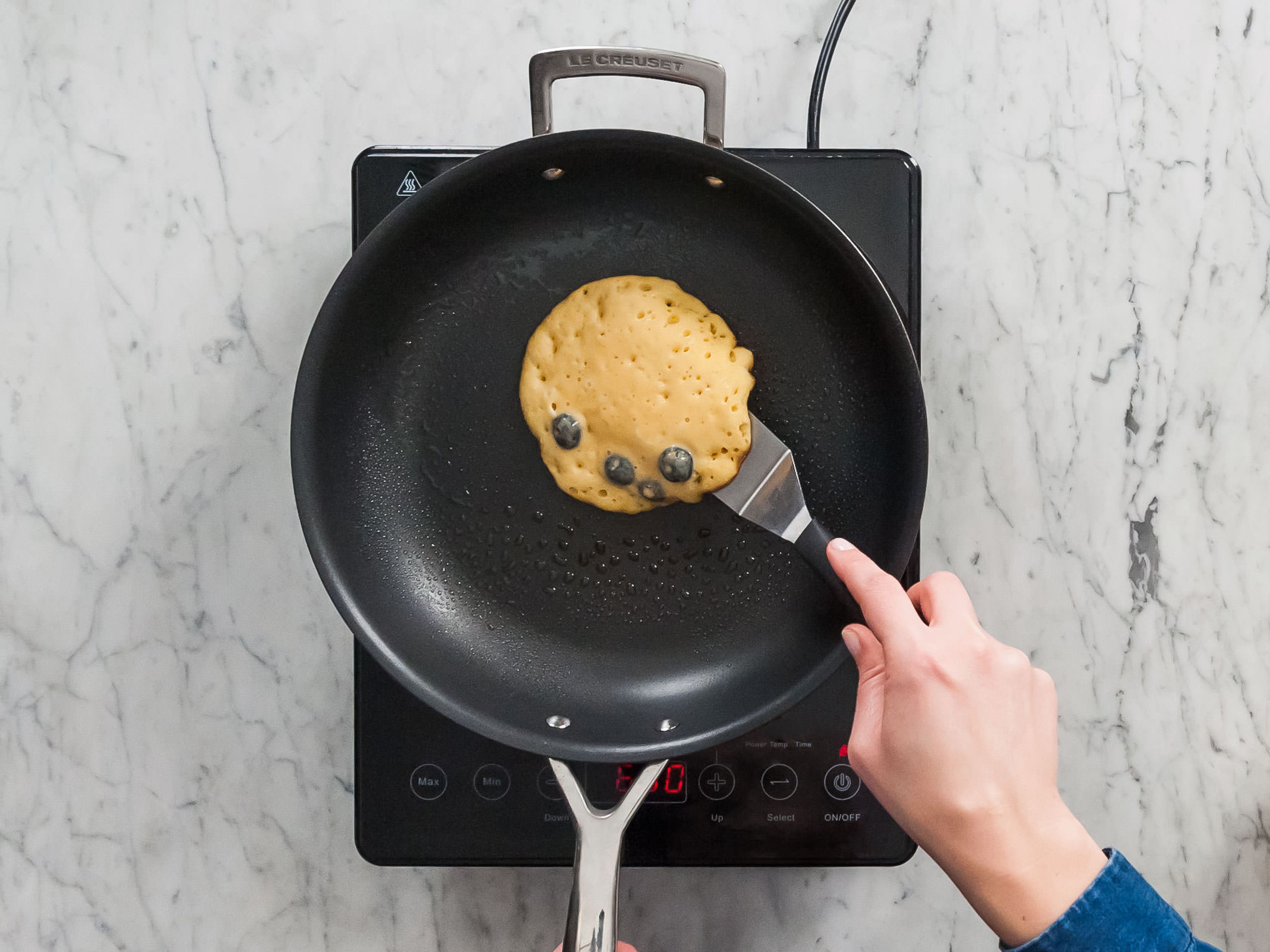 Spray large pan or griddle with nonstick cooking spray. Heat over medium heat. Spoon a small mount of batter onto hot pan. Cook until the batter bubbles begin to burst and edges are crisp up.