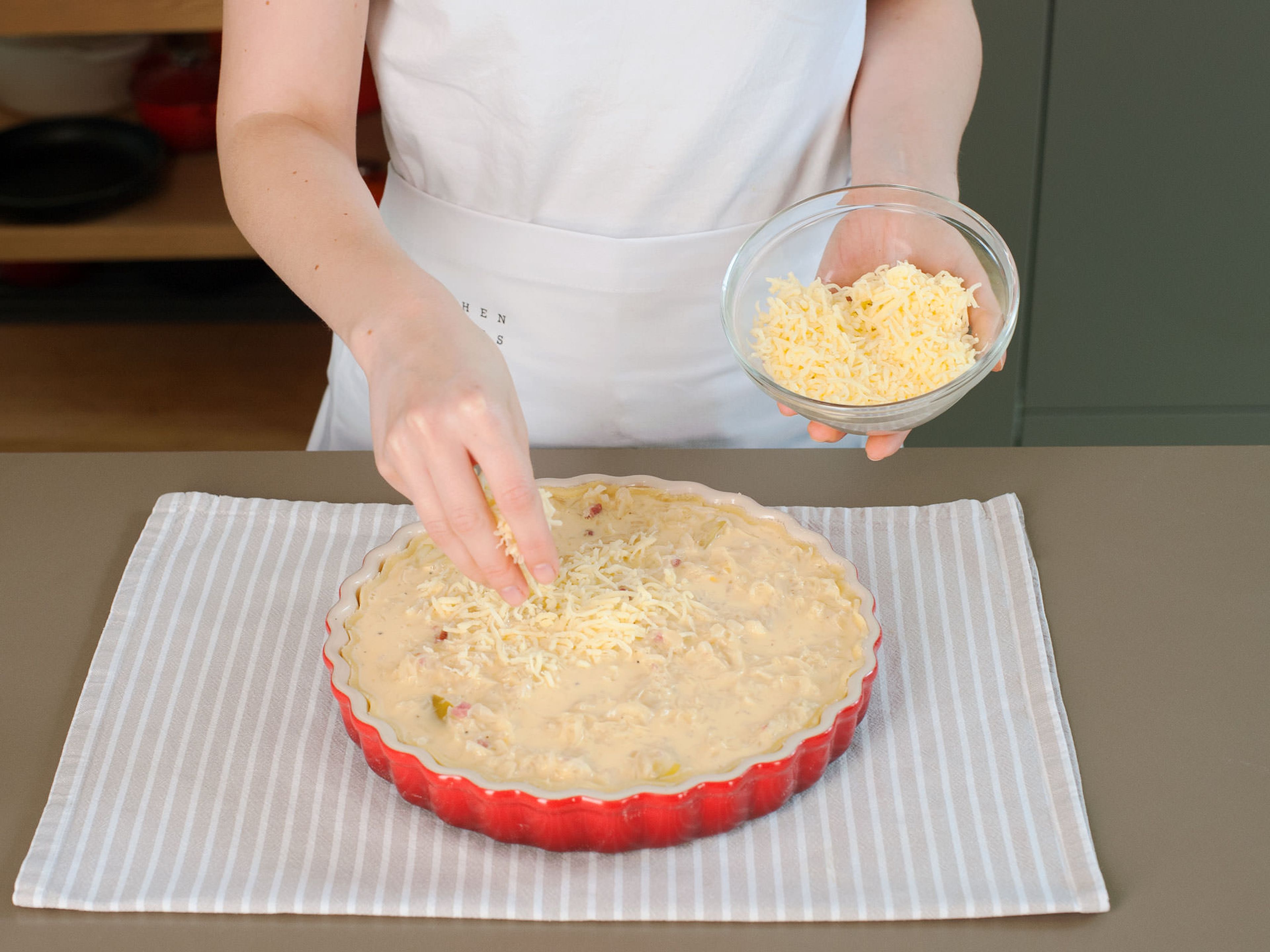 Evenly distribute sauerkraut mixture in pie dish, pour egg and cream mixture on top, and sprinkle with grated cheese. Place in preheated oven and bake at 180°C/350°F for approx. 25 – 30 min. until golden brown. Serve warm immediately. Enjoy with a dollop of crème fraiche on top, if desired!