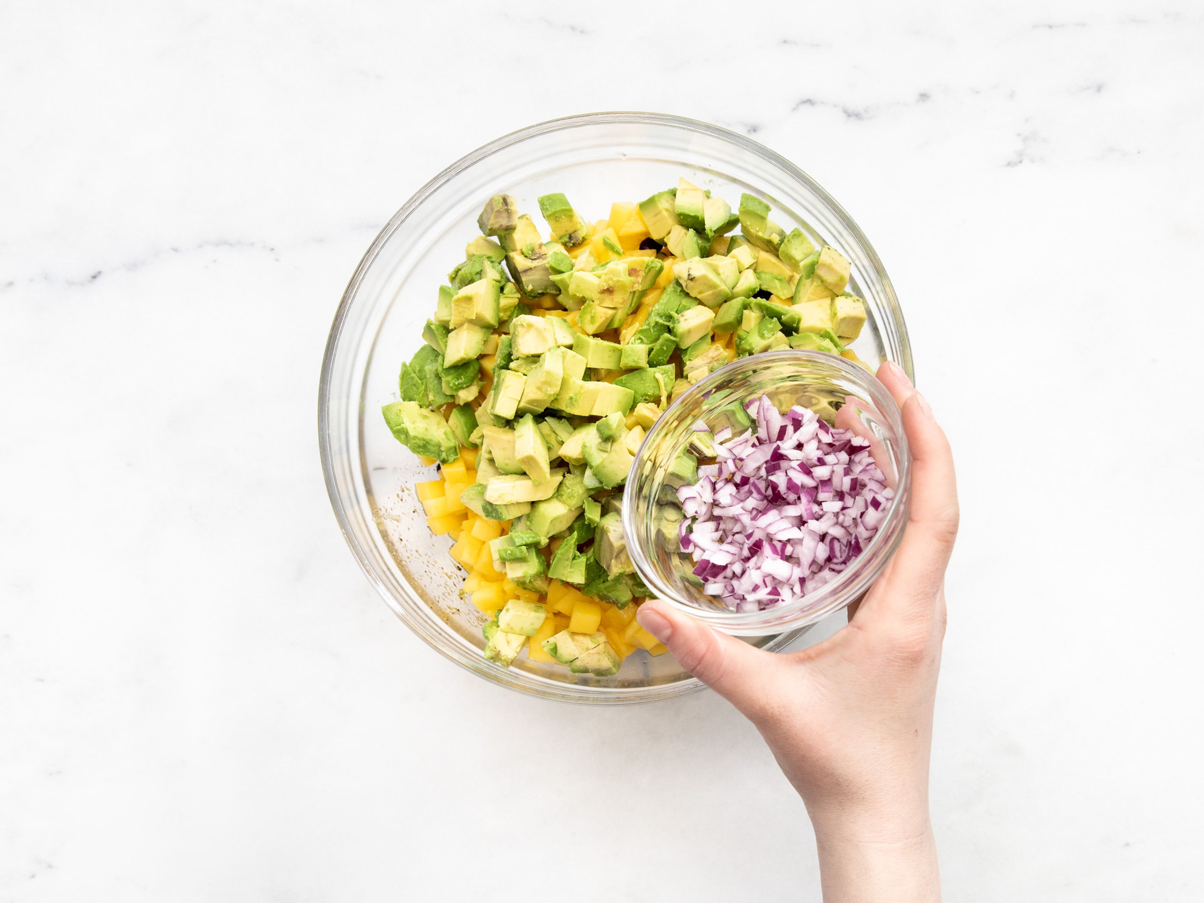 Drain the corn and black beans and add to the bowl with the lime dressing. Mix together with the avocados, mango, and red onion. Serve with tortilla chips and cilantro. Enjoy!