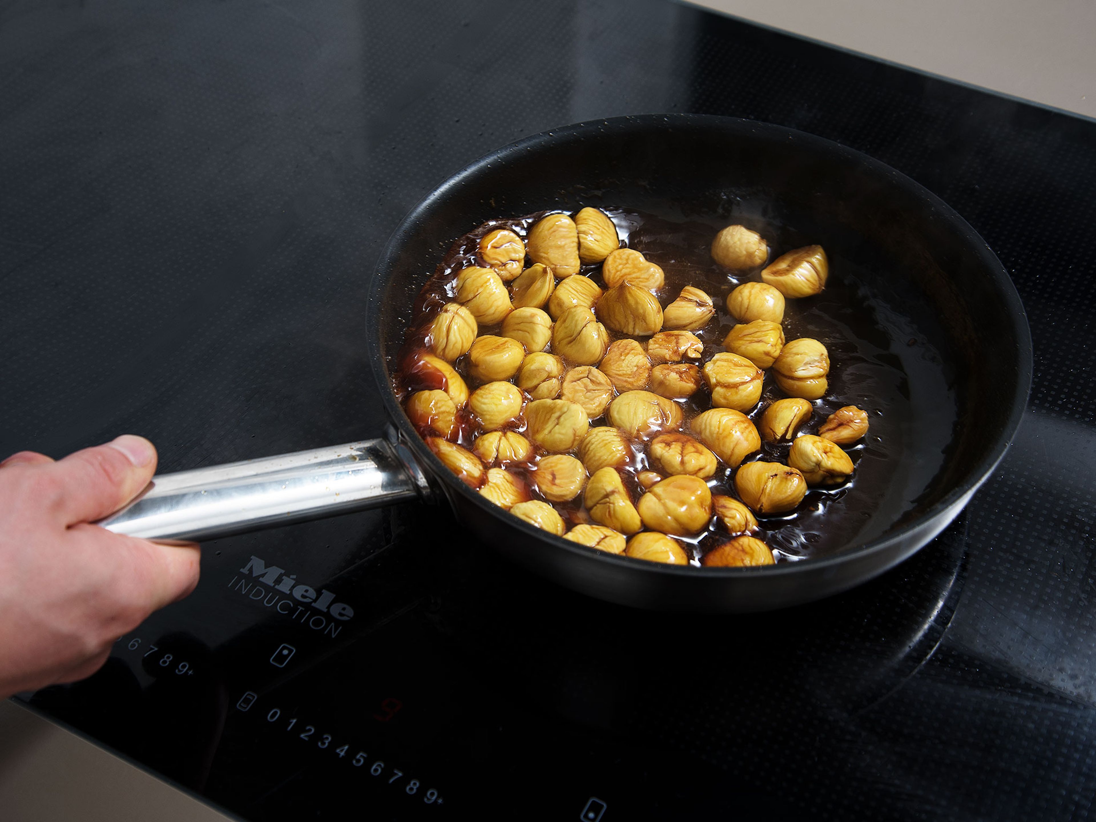 Add sugar to a pan over medium heat and caramelize, add water and bring to a boil. Add chestnuts and butter, reduce heat to low, making sure the caramel does not burn. Gently stir the pan to coat chestnuts with caramel and leave to simmer for approx. 2 min.