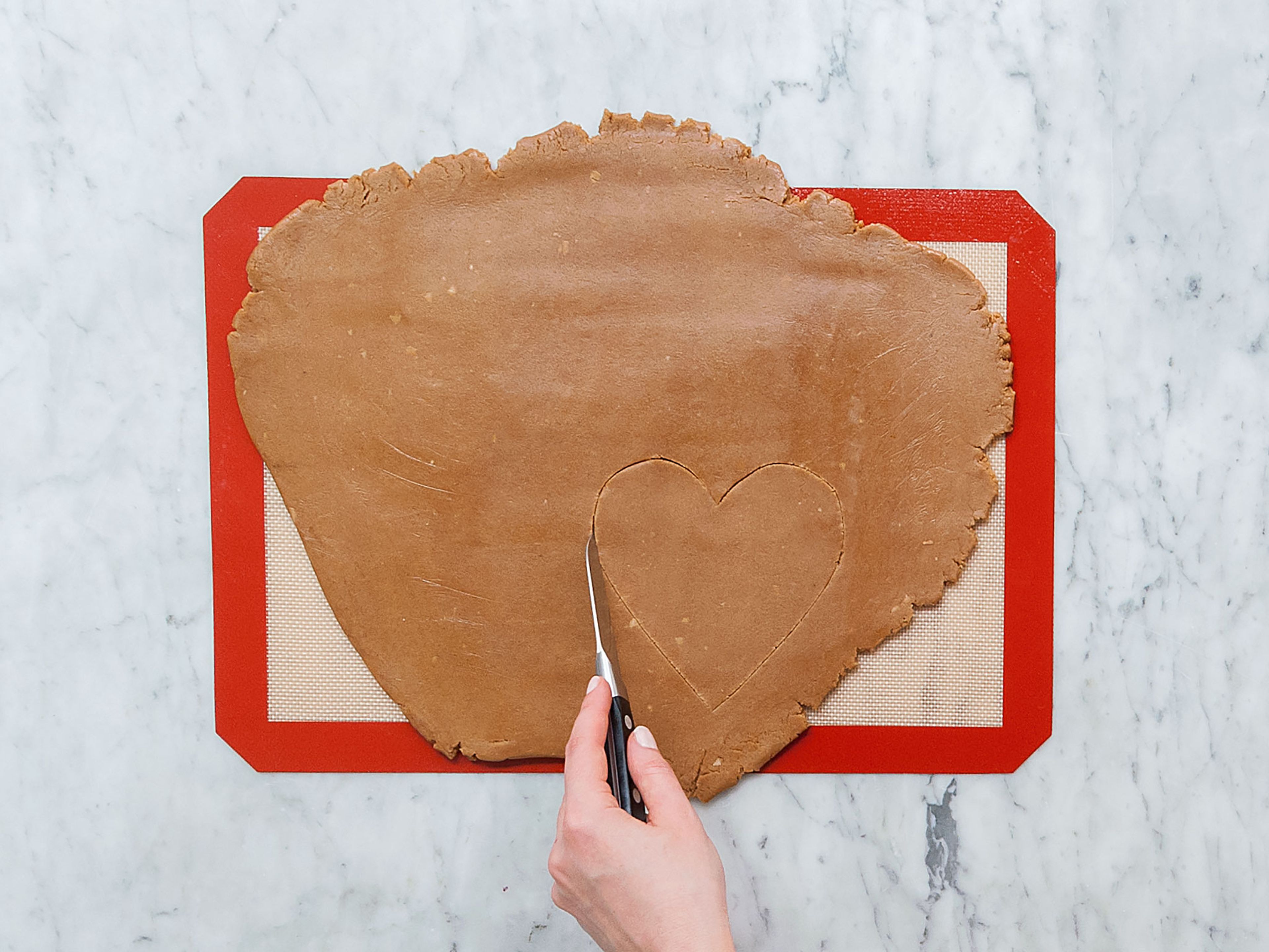Preheat oven to 200°C/390°F. Roll out dough on a silicone baking mat or in between two sheets of plastic wrap. It should be 1-cm/0.4-in thick. Cut out ten heart-shaped forms and transfer them onto two parchment-lined baking sheets. Bake in the oven for approx. 12 – 15 min. Remove from oven and transfer onto a neutral underground when still warm. Let cool down completely.