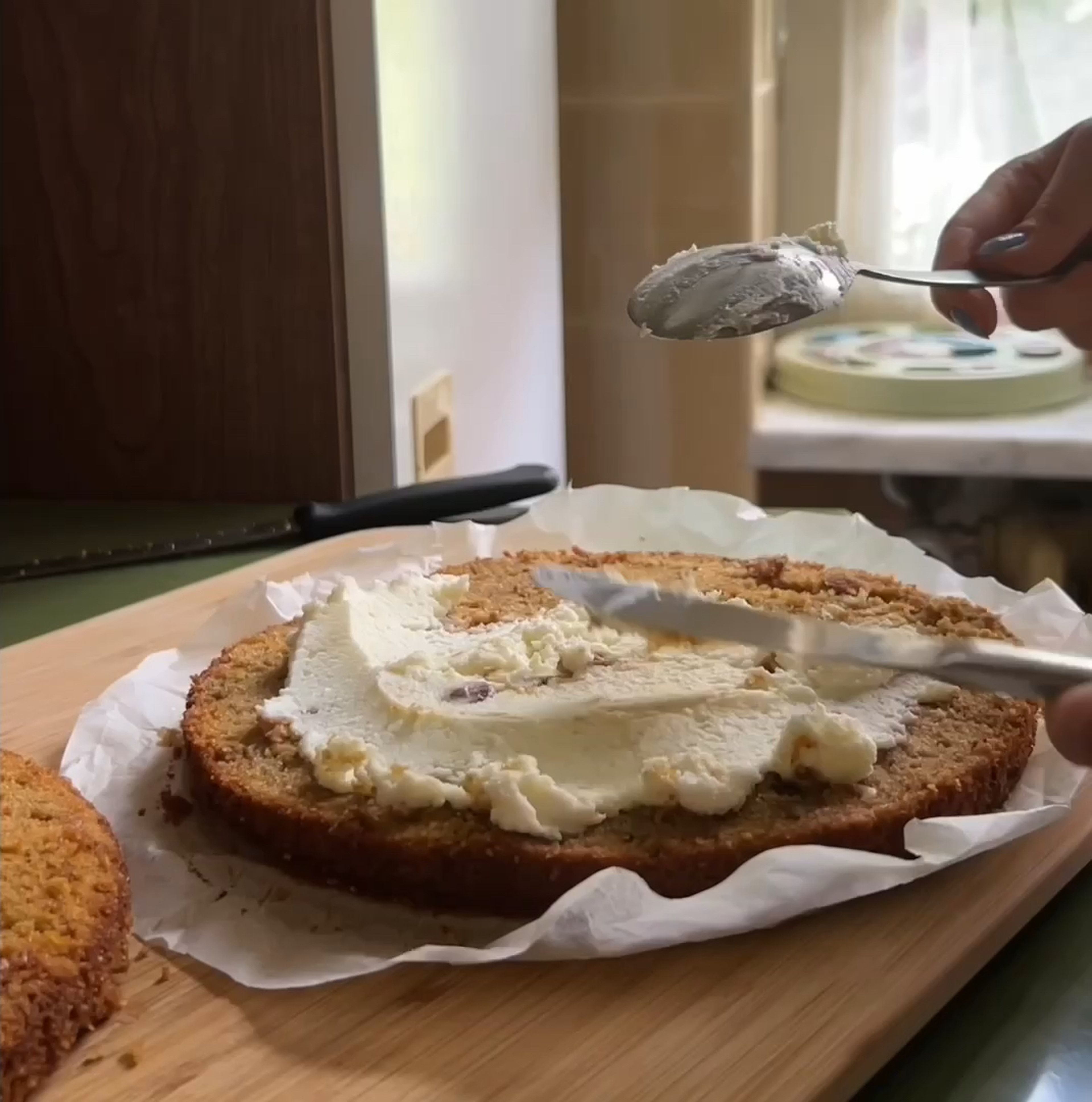 Time to assemble the cake, eyeballing divide the cream cheese frosting in halves and start by covering with cream cheese the first layer and sprinkle some lemon zest on top. Put the second layer on top and again cover it with the frosting, smooth the sides and the top with any tool you have in the kitchen.