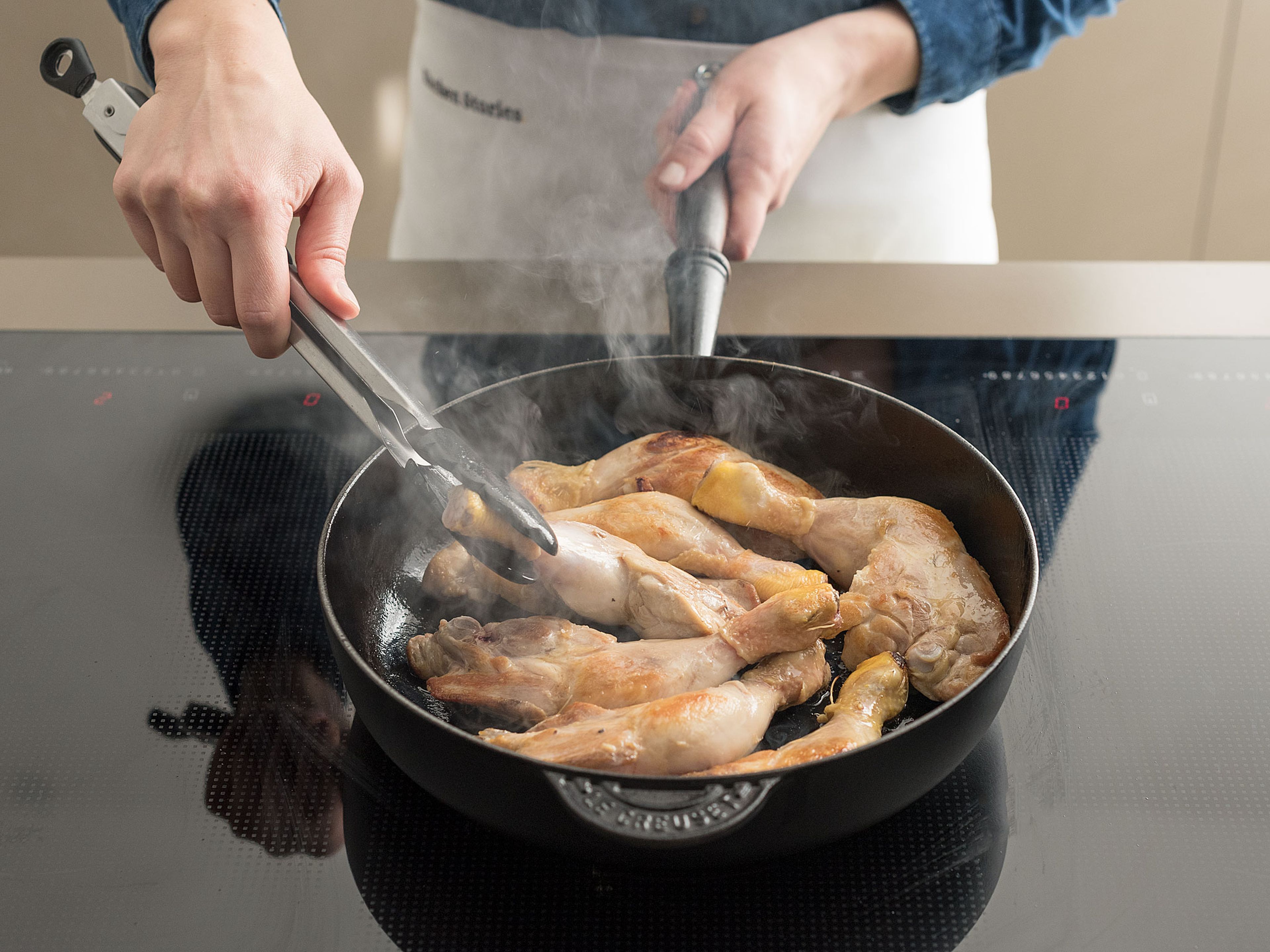 Spray large frying pan with cooking spray. Brown chicken on all sides over medium heat. Place chicken in slow cooker in a single layer.