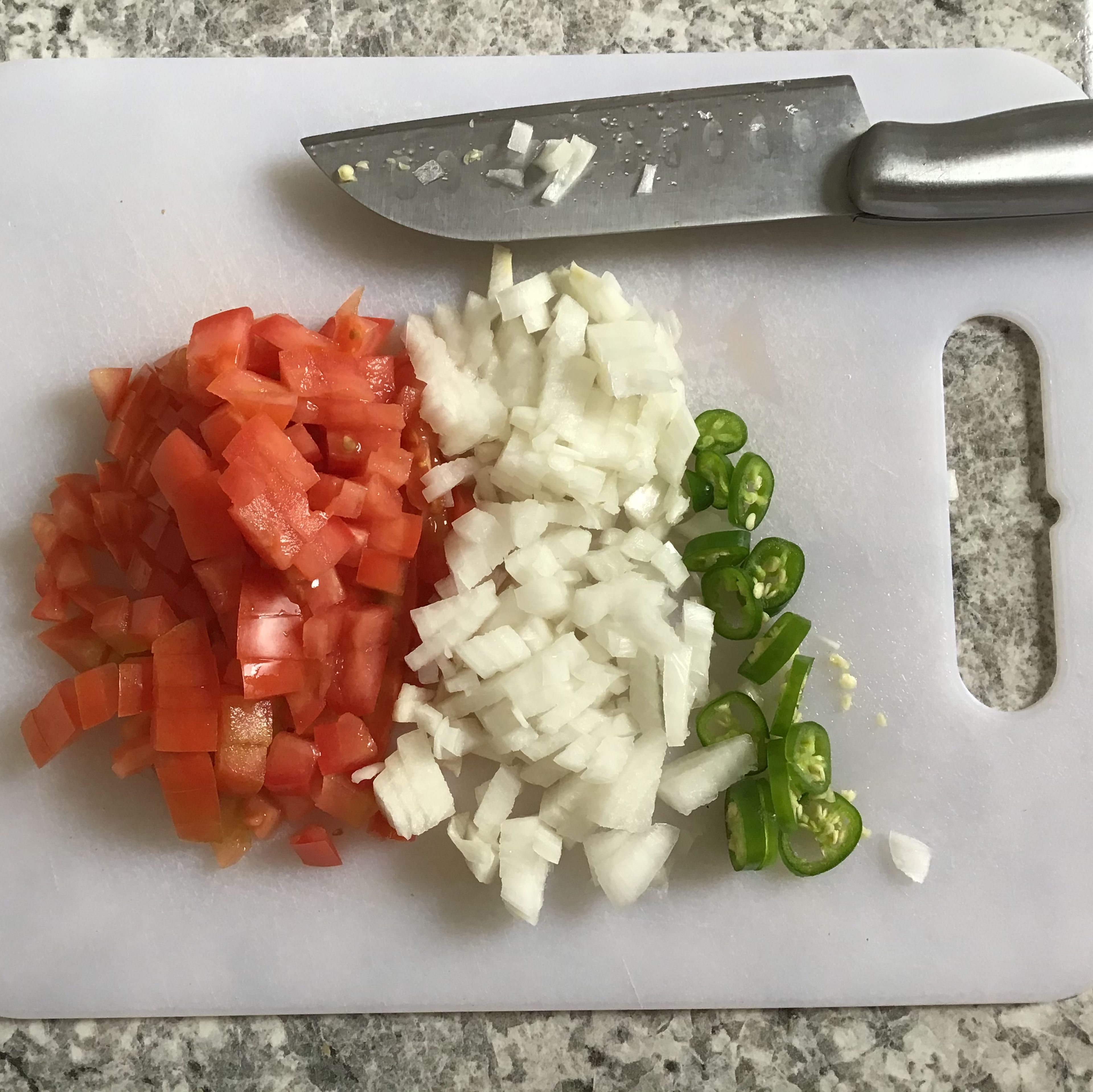 - Wash your hands - Chop up the tomato and onion into small cubes. - Chop up Serrano pepper into small circles or however you want.