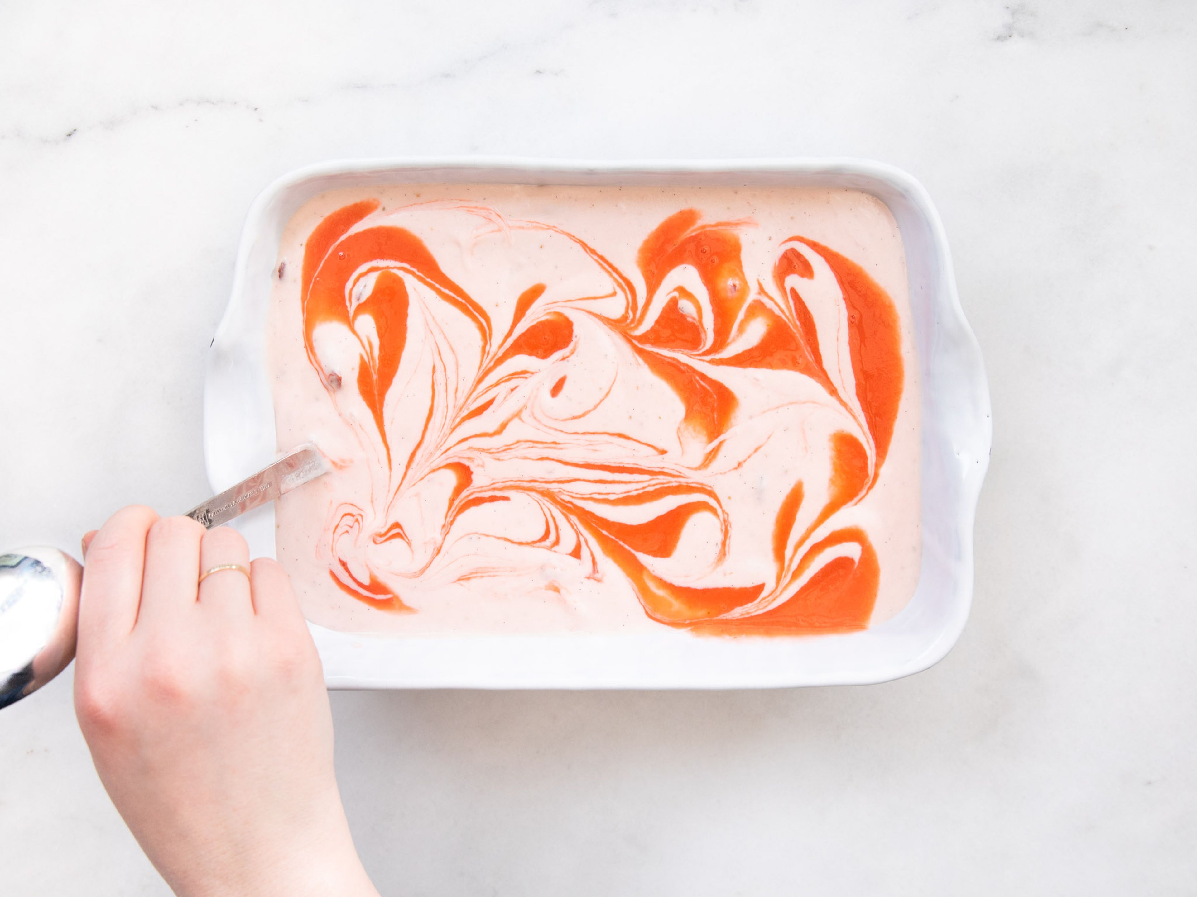 Pour ice cream mixture into a baking dish and pour the remaining purée over the top. Use the handle of a spoon to swirl purée into a marble pattern. Transfer to the freezer for approx. 3 hrs., or until frozen to your liking. Let mixture rest briefly at room temperature to soften before serving. Enjoy!