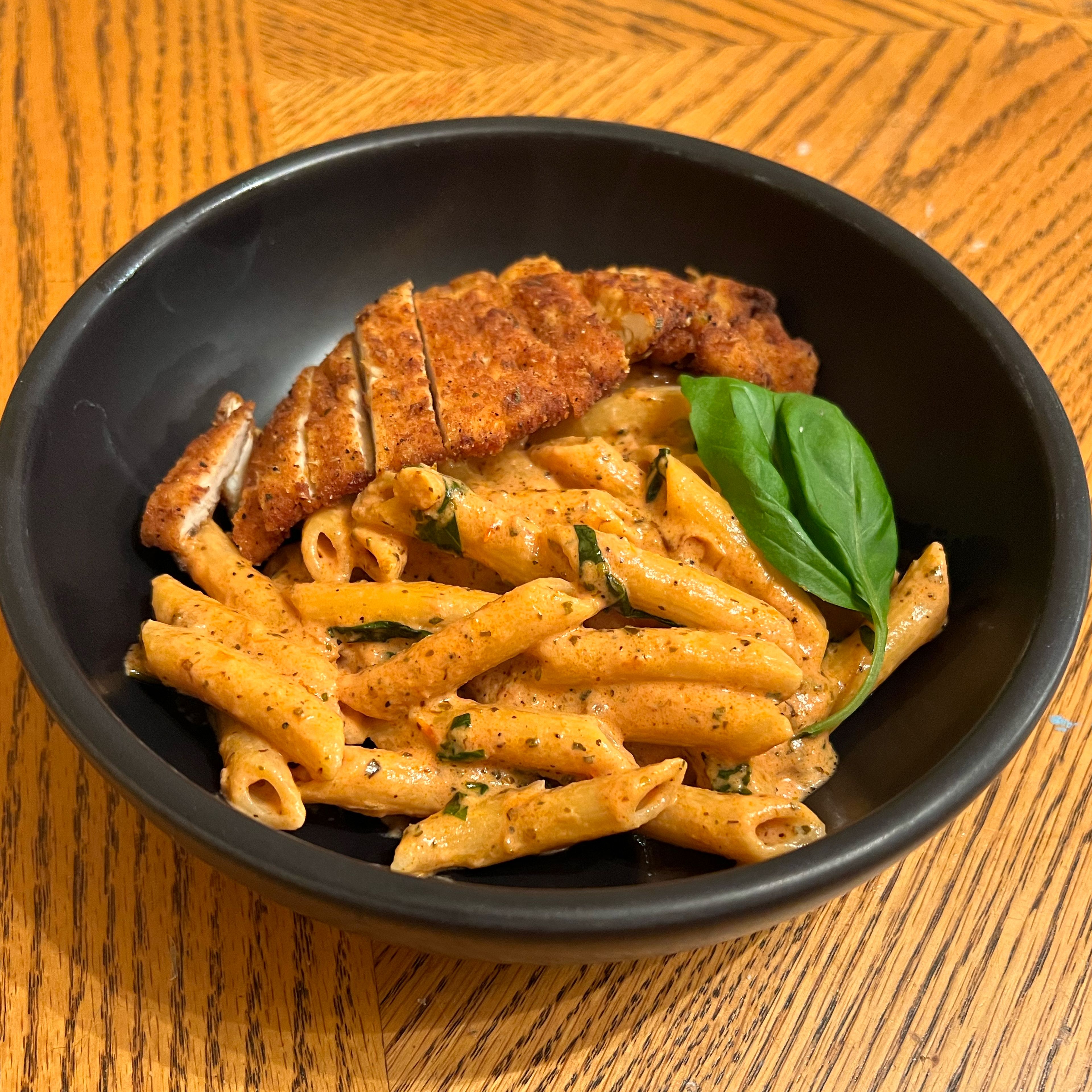 slice your chicken, plate your pasta, garnish with basil leaves and CONSUME!