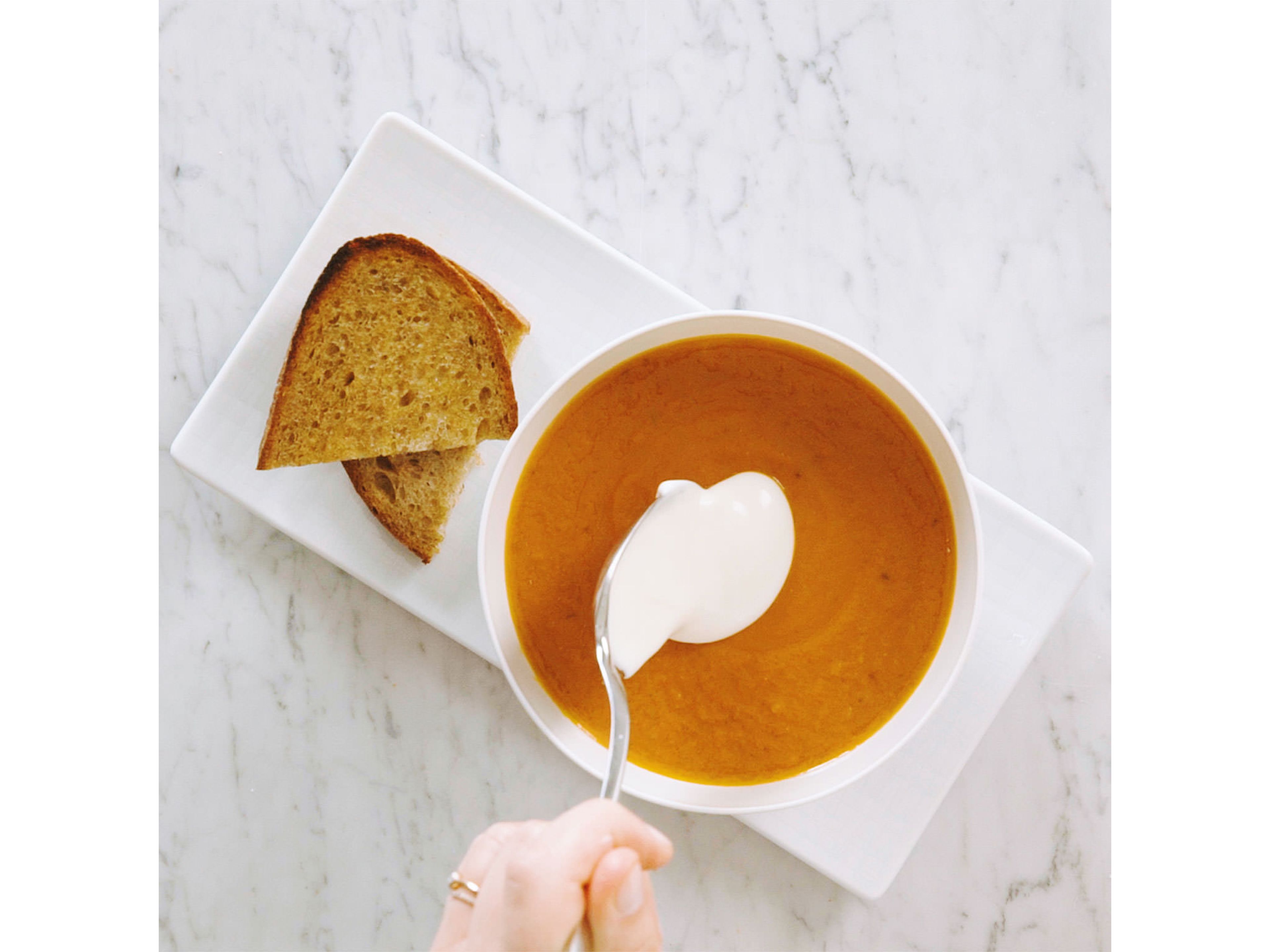 Transfer to a serving bowl and dollop with yogurt alternative. If you like, garnish with pumpkin seed oil. Serve with slices of whole wheat bread. Enjoy!