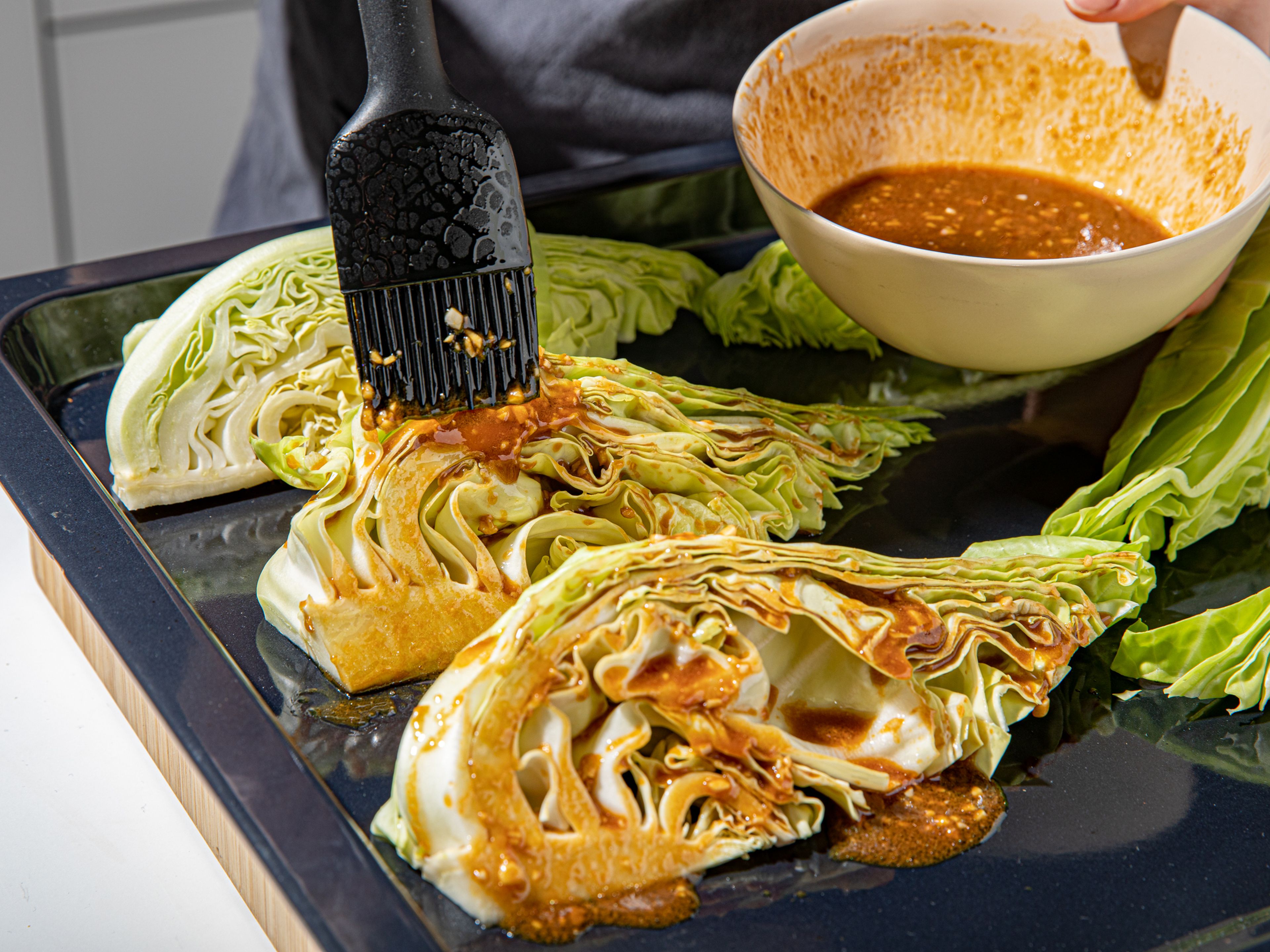 Arrange the cabbage wedges on a baking sheet and brush with all the marinade. Transfer to the oven and roast for approx. 35 min. Halfway through, brush the cabbage with any marinade that’s slipped off onto the baking sheet. Arrange cabbage on a serving plate, and sprinkle with sesame seeds and scallions before serving. Enjoy!