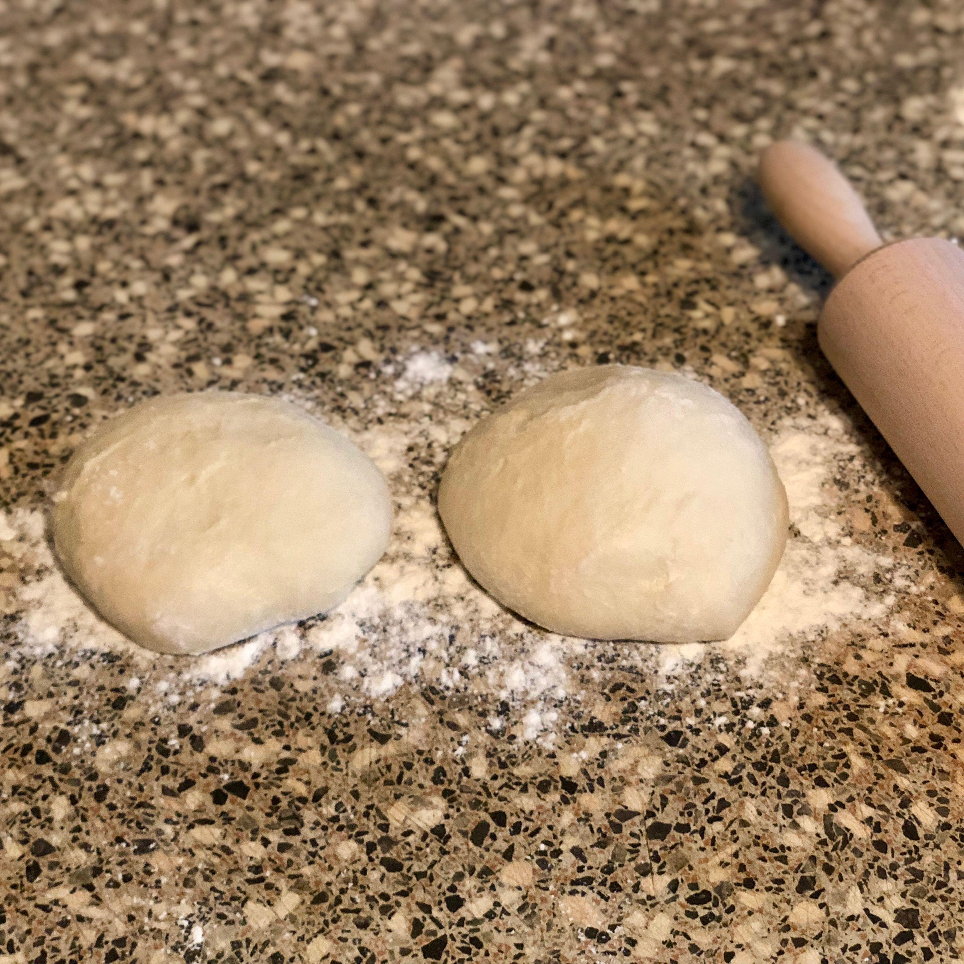 Cut the dough into two portions and shape into balls.