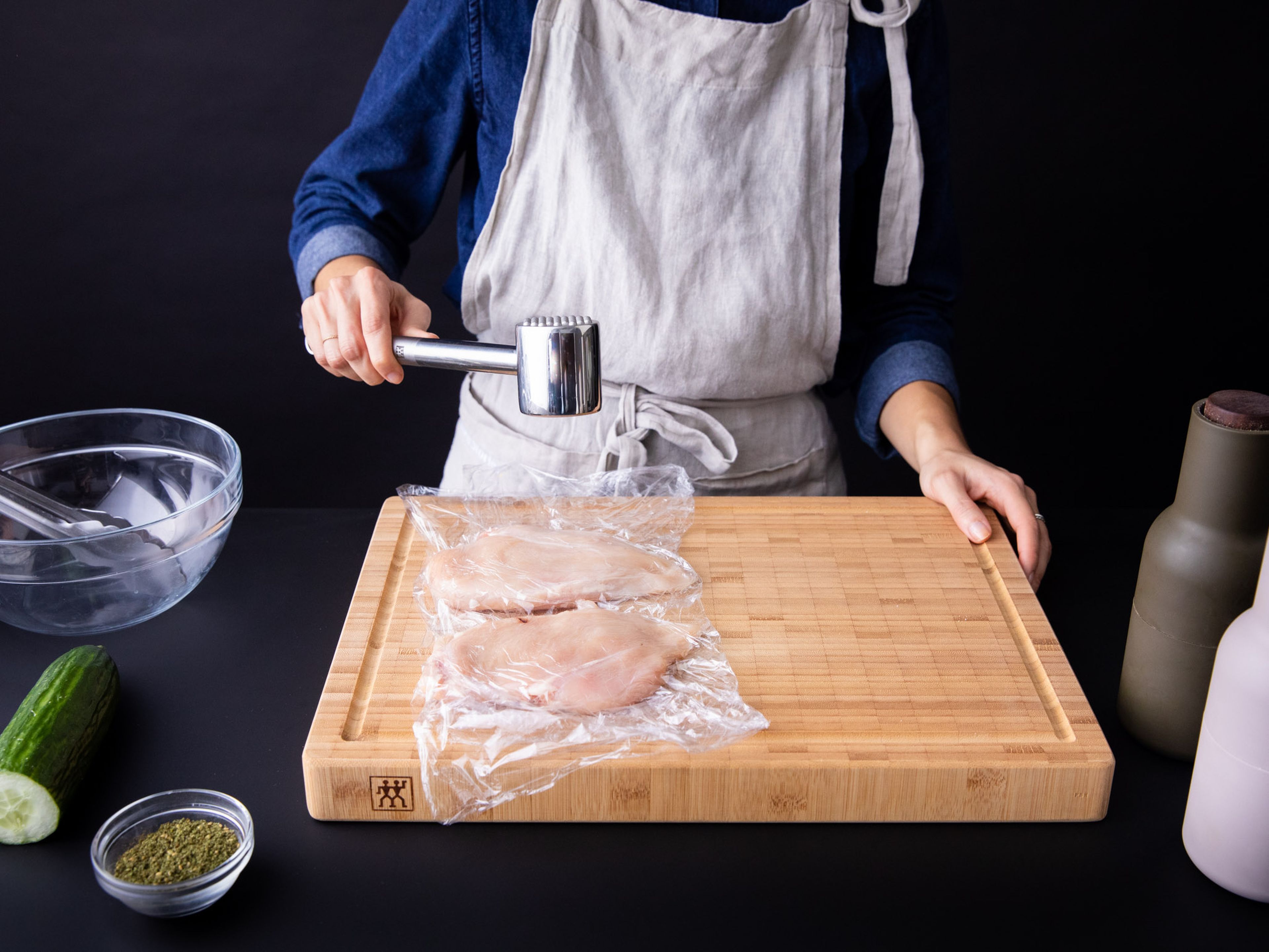 Spread a layer of plastic wrap over a cutting board and place the chicken breasts in the middle with some space between them. Add another layer of plastic over the chicken and pound them with the smooth side of a meat tenderizer just to make the chicken breast even in thickness. Season the chicken thoroughly with salt and pepper, some olive oil, and the Za’atar.