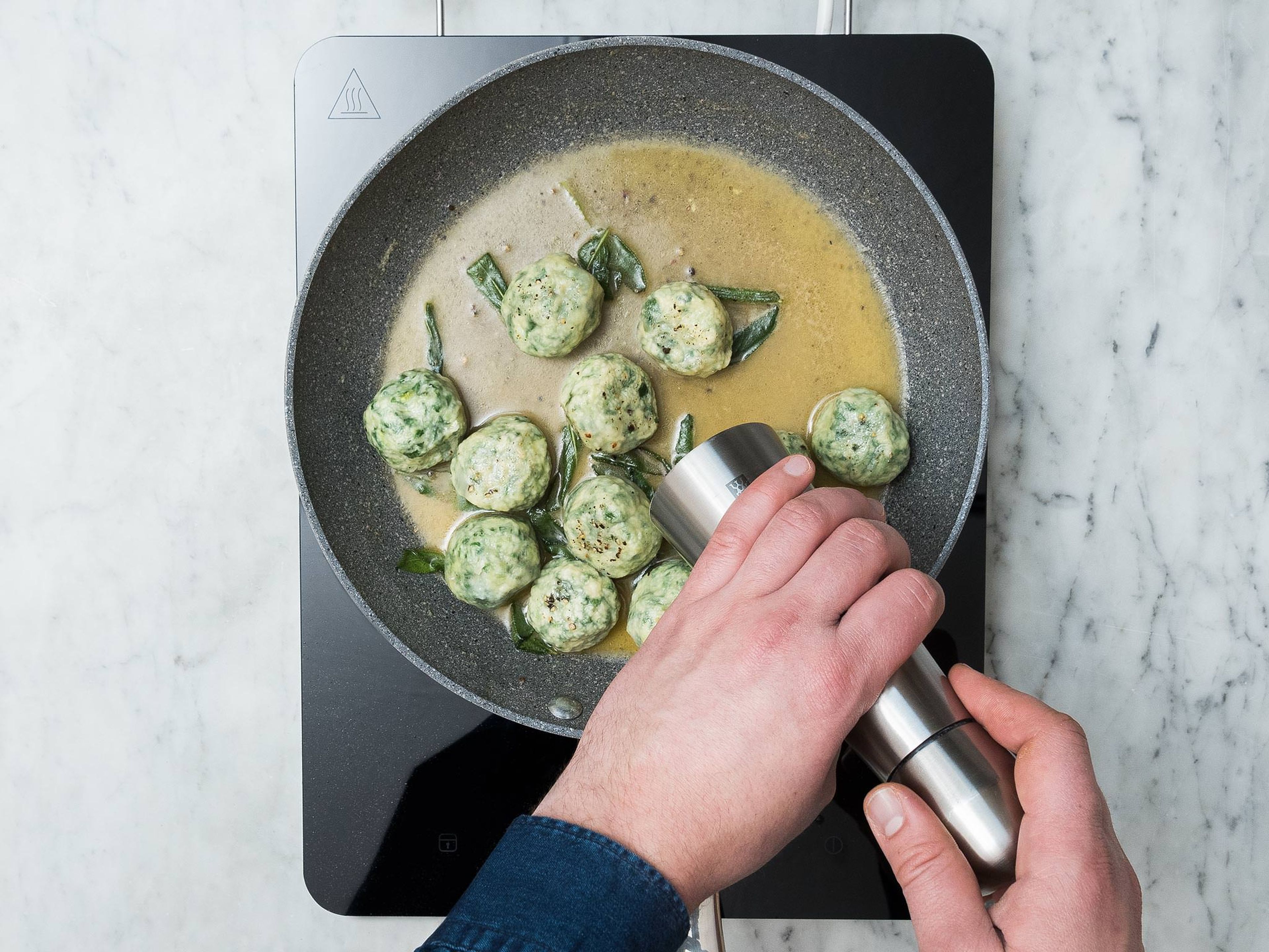 In the meantime, prepare the sauce by melting the butter in a frying pan over medium heat with the sage leaves. When butter is melted and before it begins to brown, add about 2-3 spoonfuls of the gnudi cooking water and swirl the pan to create a thick sauce. Season with salt and pepper, adding more gnudi cooking water if needed.