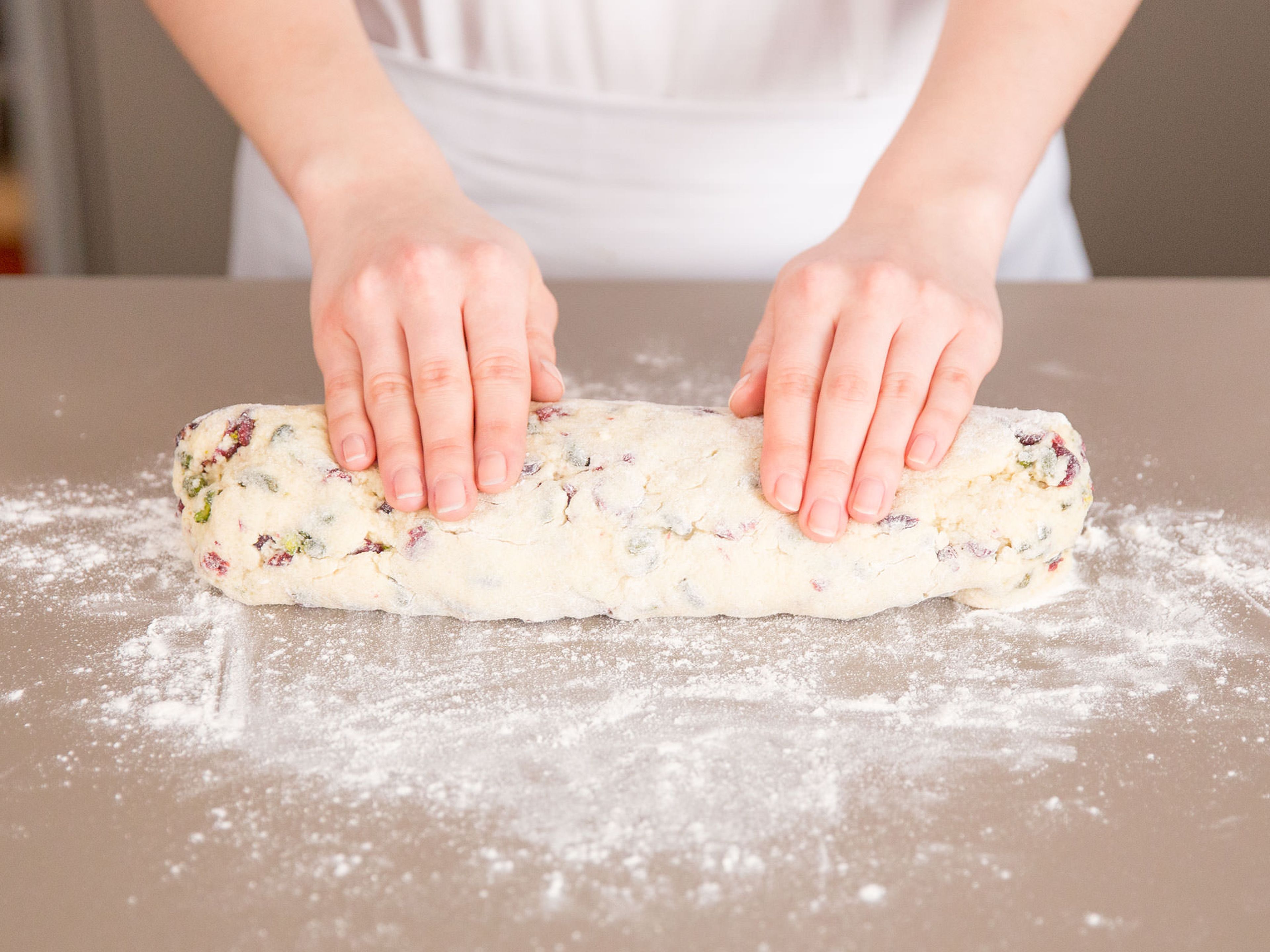 Next, roll the dough into a log. Press the dough tightly together, as it can be quite crumbly due to the cranberries and pistachios.