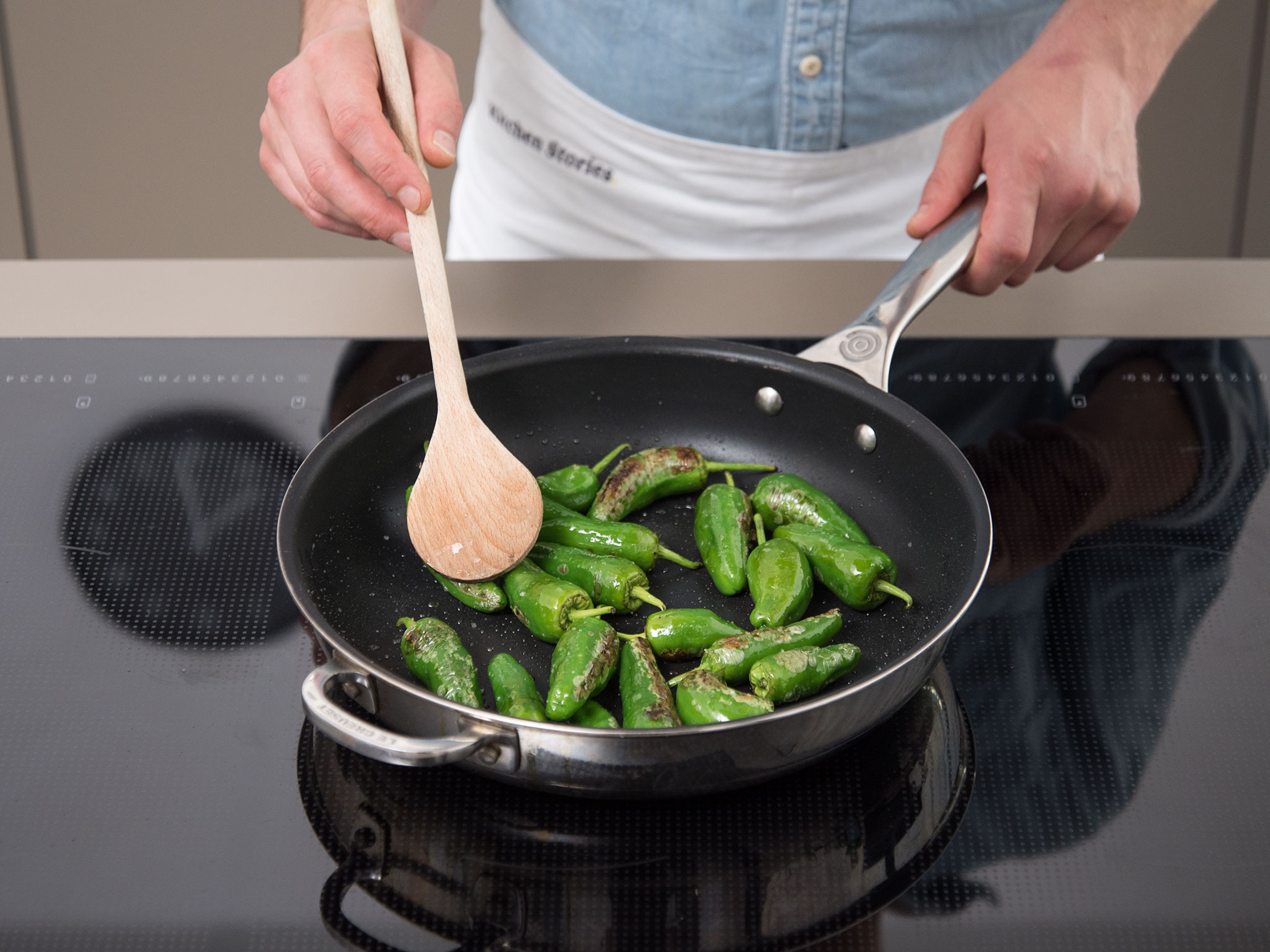 Add Padrón peppers to the same frying pan and fry for approx. 2 – 3 min. on medium-high heat until slightly charred.