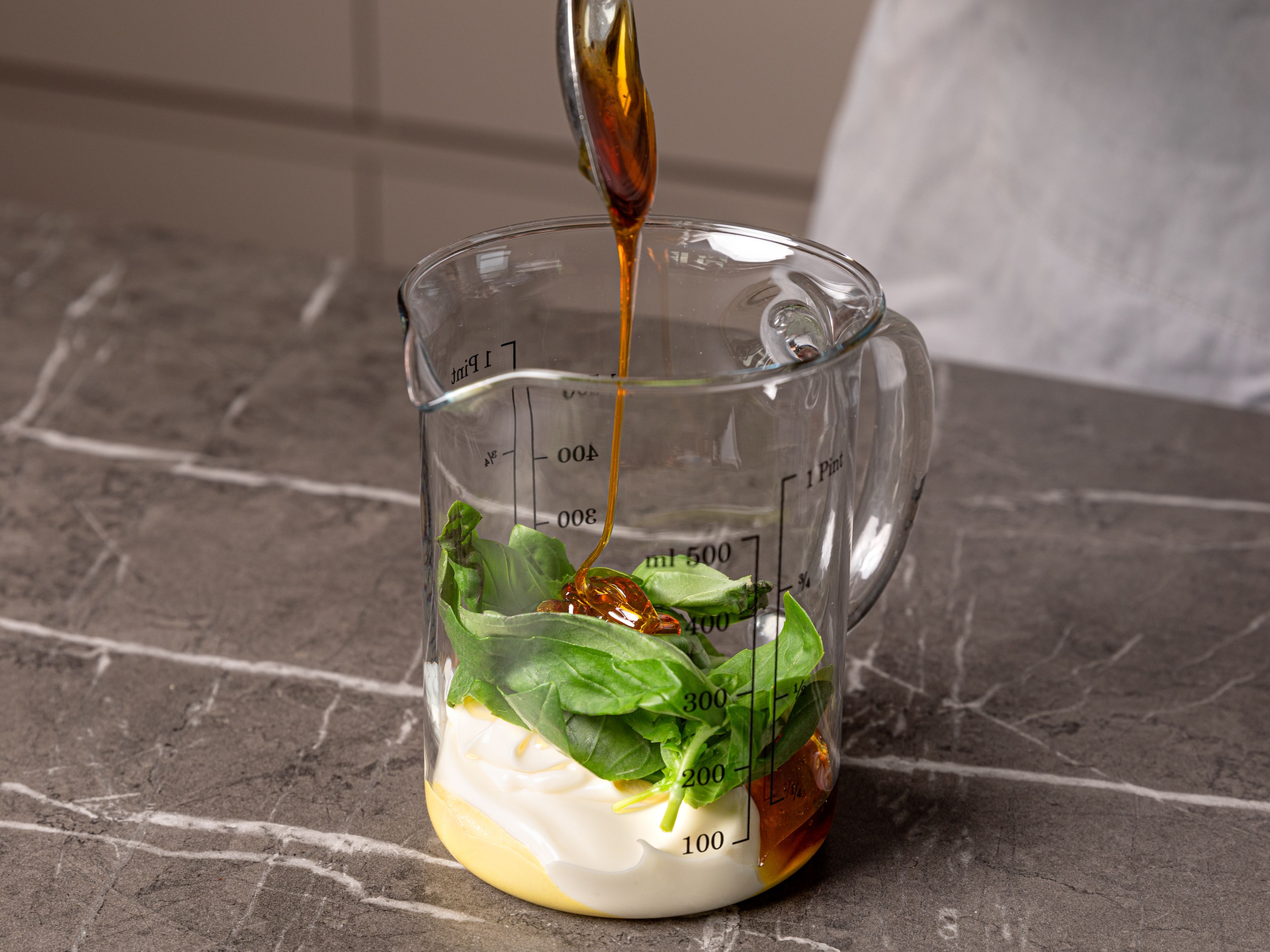 Meanwhile, boil the eggs until the yolk is slightly runny, for approx. 6-8 min. Prepare the dip: In a mixing bowl, use an immersion blender to purée the basil with the juice of half a lemon, mayonnaise, mustard, honey to a smooth dip. Season with salt and pepper.