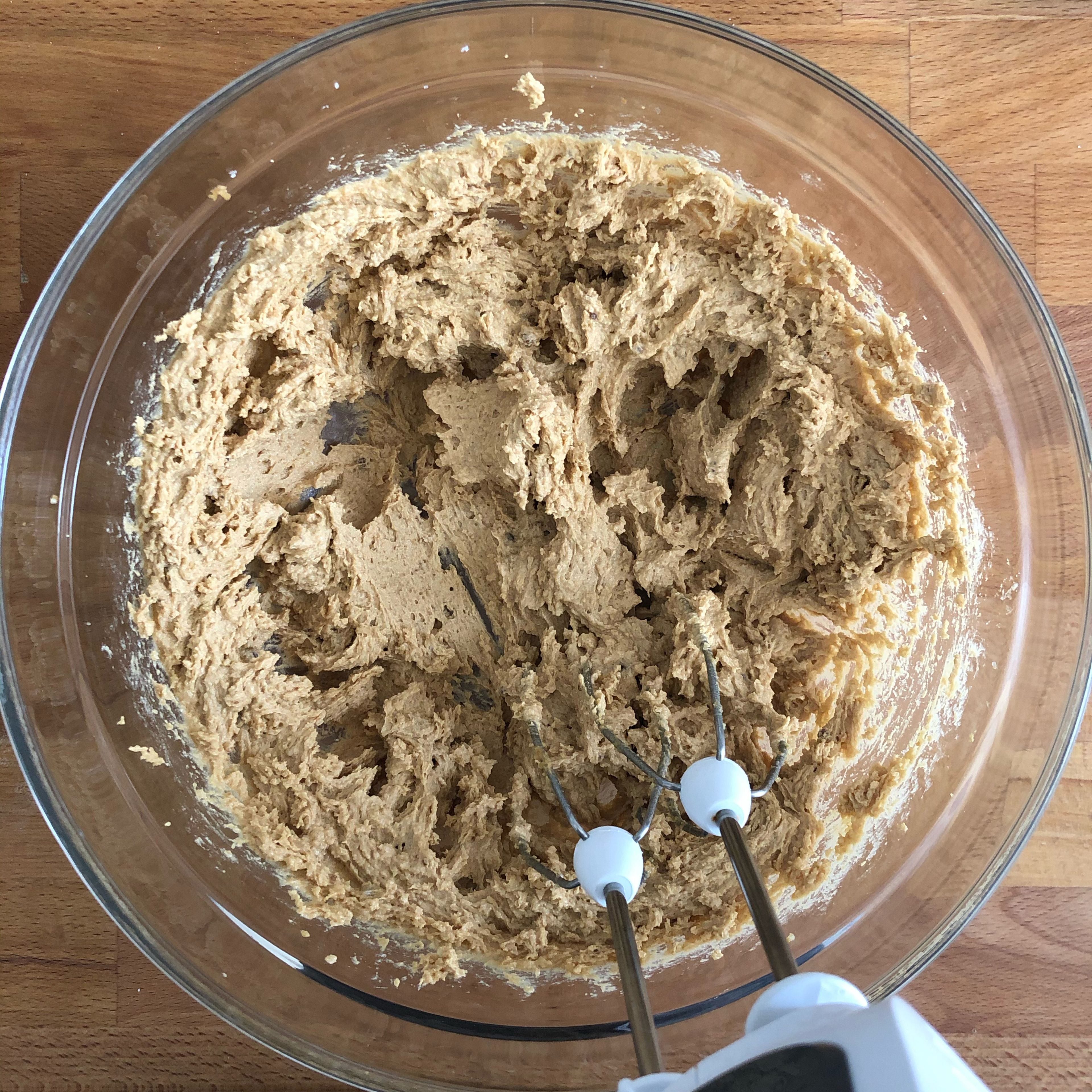 Add flour, baking soda, and baking powder a bowl and mix to combine, then set aside. Add butter, brown sugar, and sugar to a separate bowl and beat with a hand mixer until very light and fluffy, approx. 5 min.