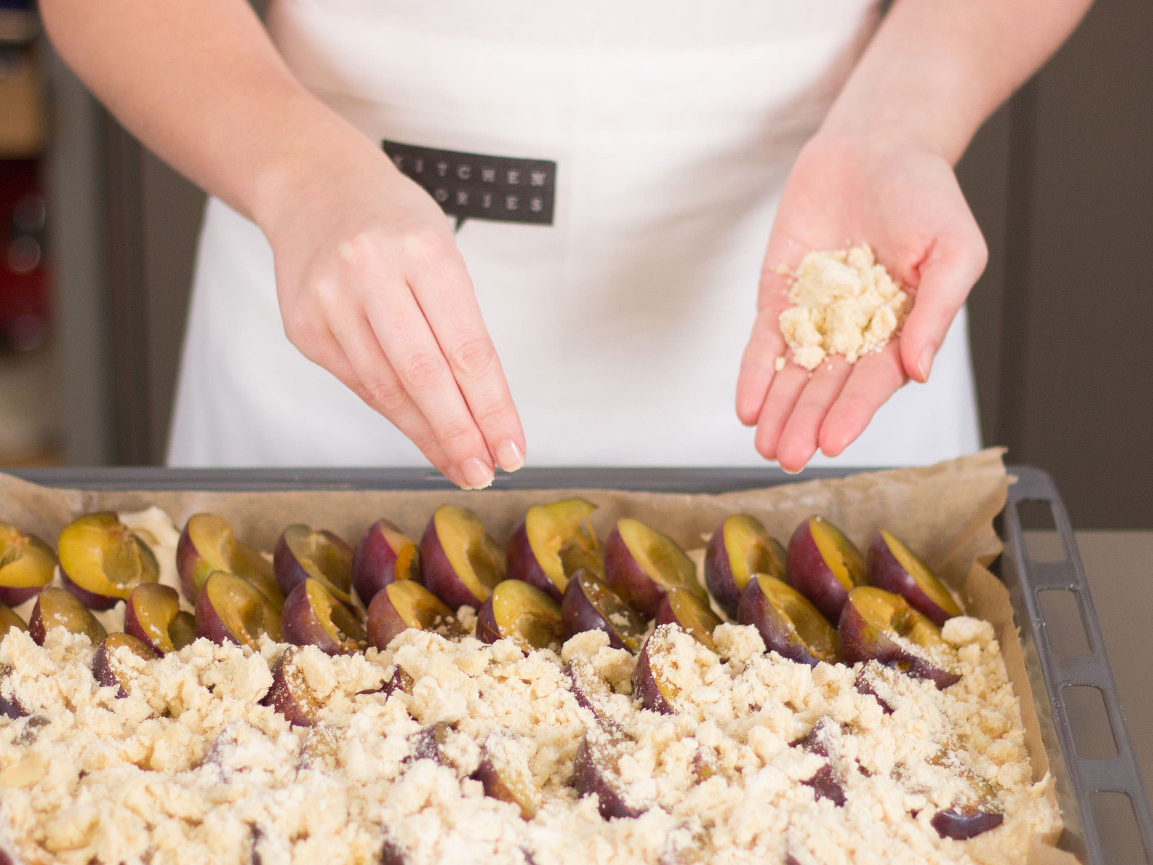 Arrange plum halves on the dough in overlapping rows, cut side facing up. Sprinkle a thick layer of crumbles on top of the cake and bake in preheated oven at 180°C/350°F for approx. 1 h. Dust with confectioner’s sugar before serving and enjoy with whipped cream or vanilla ice cream, if desired.