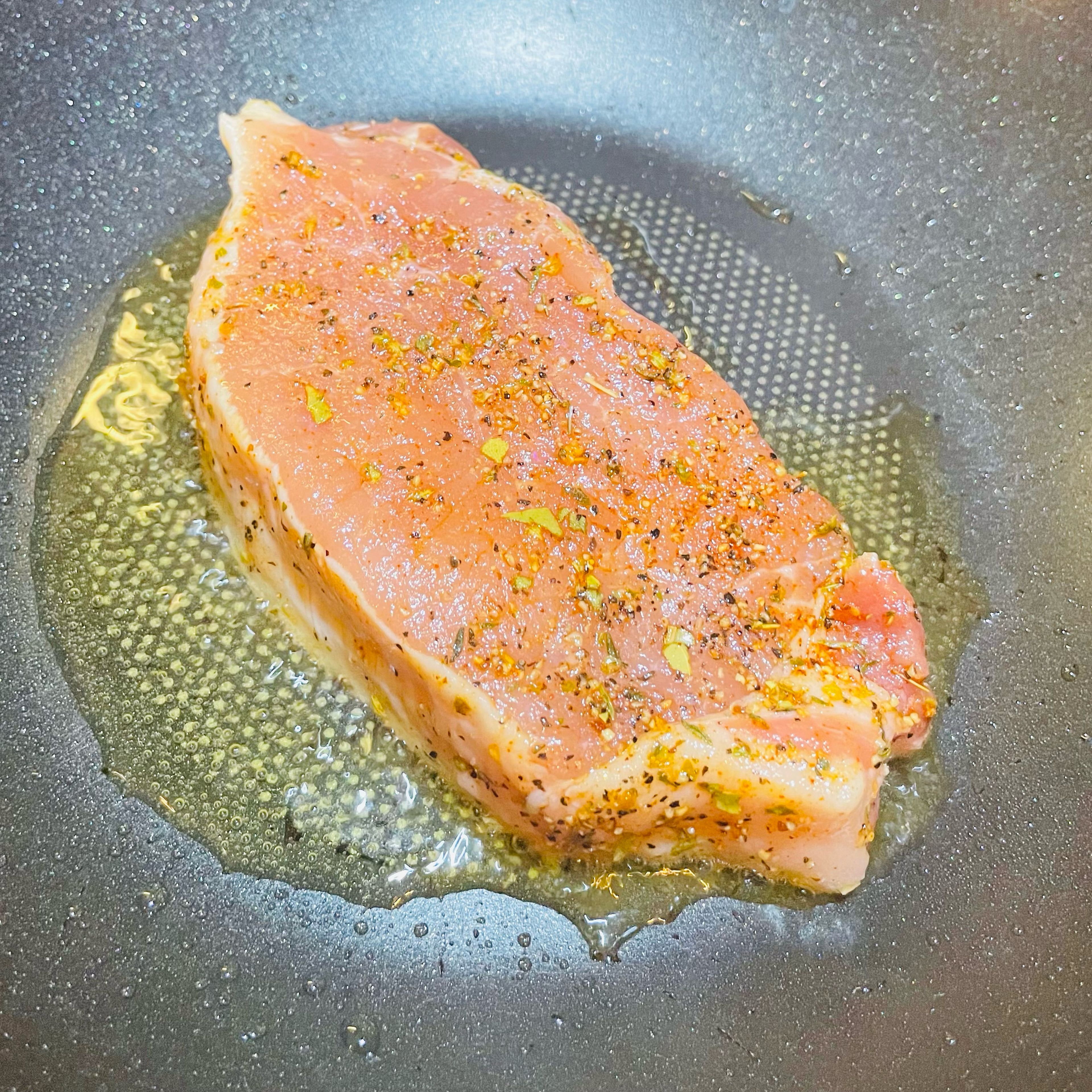 Heat frying pan and add olive oil, then add marinated pork loin. Cook for about 5 minutes each side until golden brown.