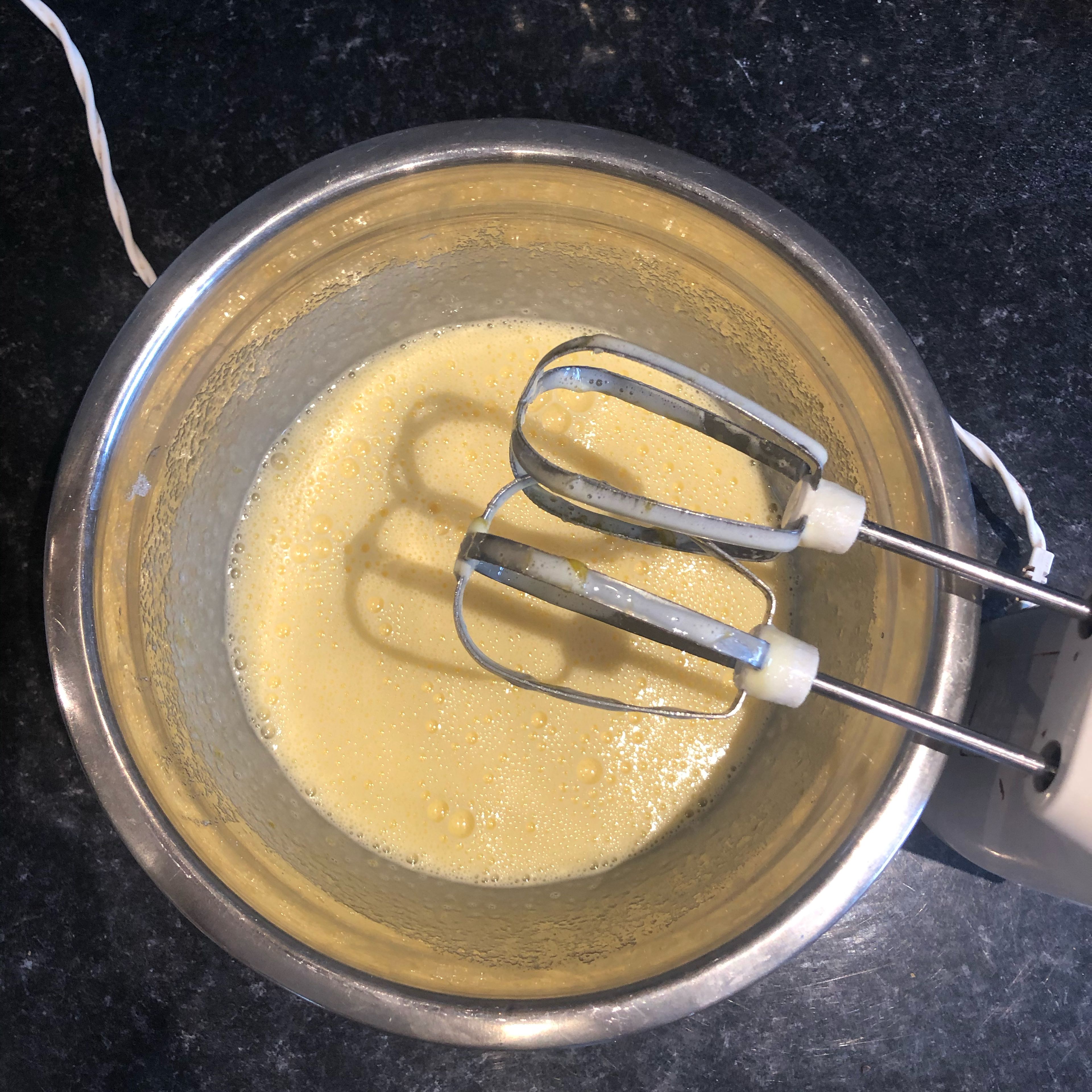 In a separate bowl, whisk together eggs and sugar until pale and light.