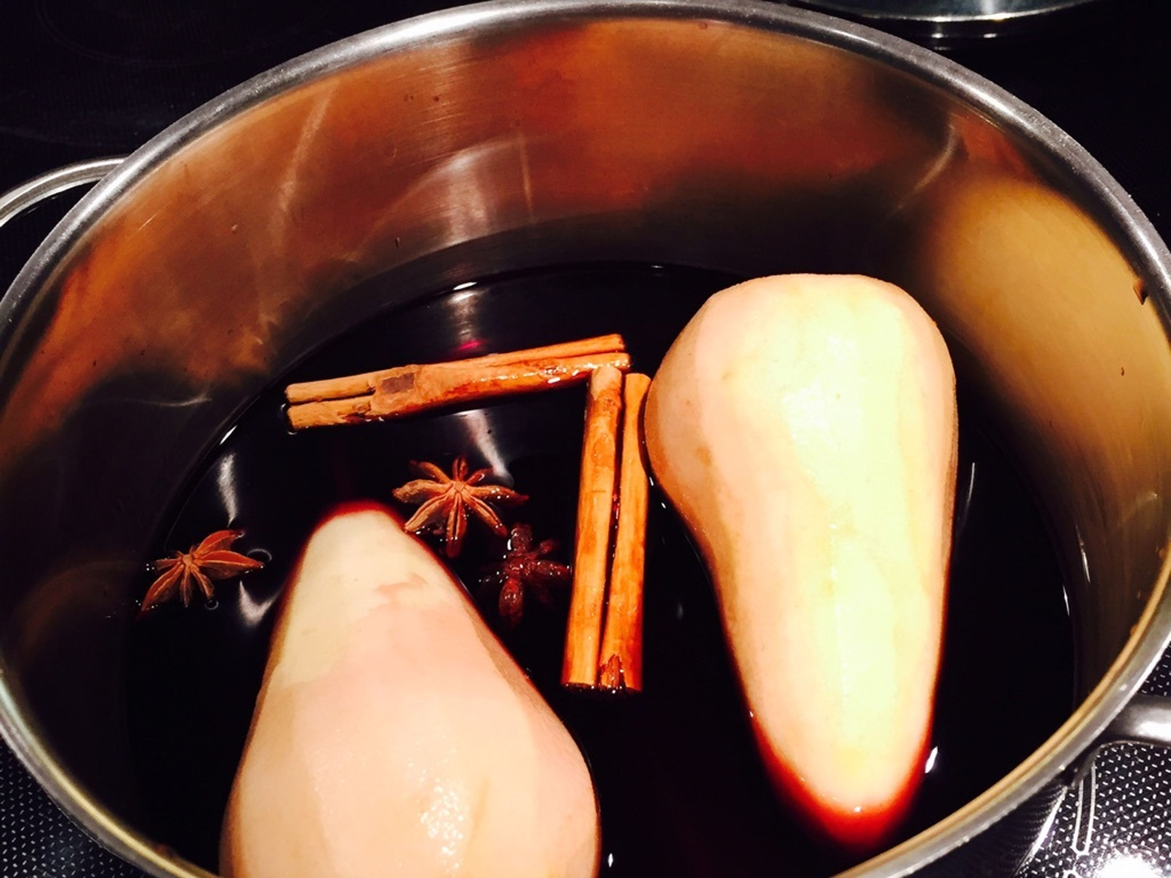 Peel the pears. Pour wine in a pot and add pears, sugar, cinnamon, and star anise.