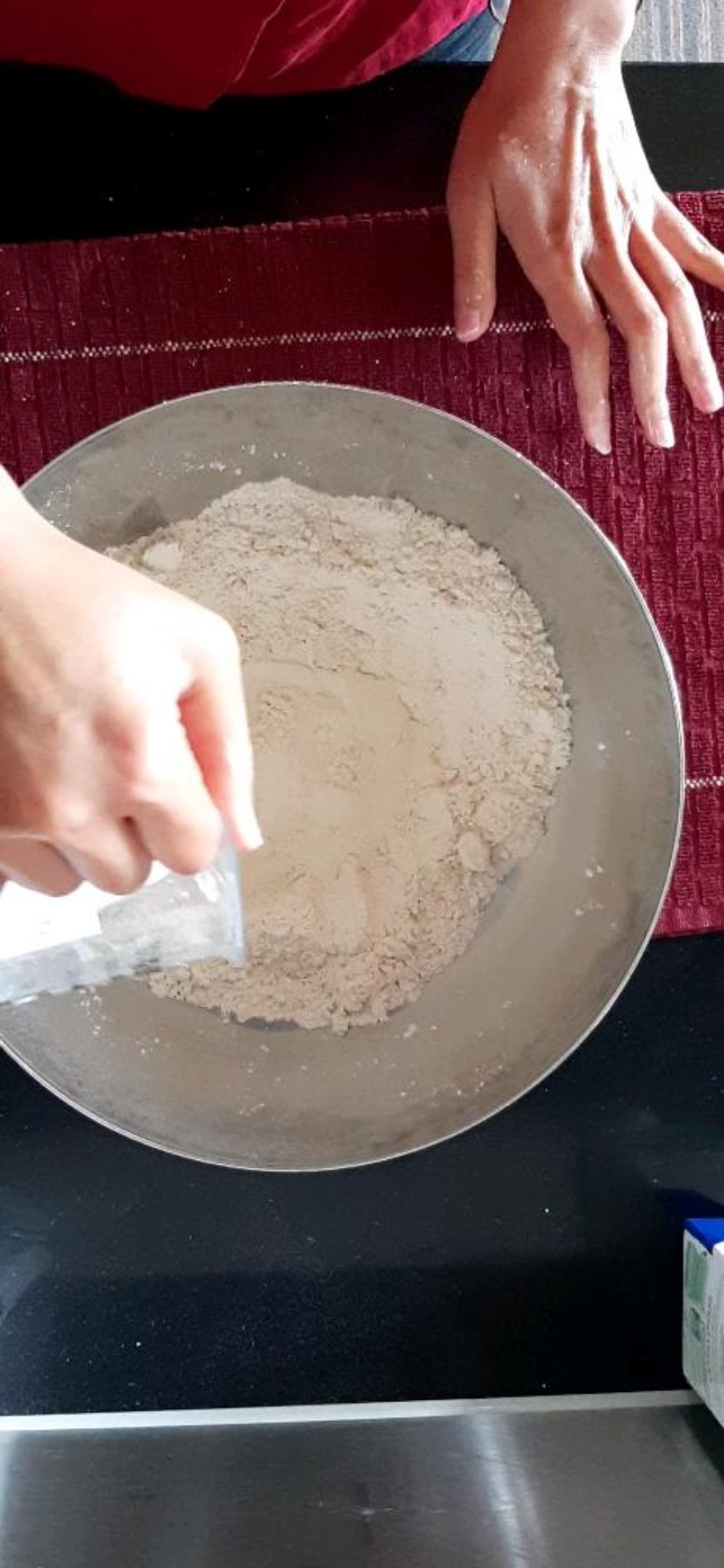 Make a well in middle of the flour mixture and pour milk. It may be useful to pour little milk at a time and mix it in the dough. I just poured everything in though 😃