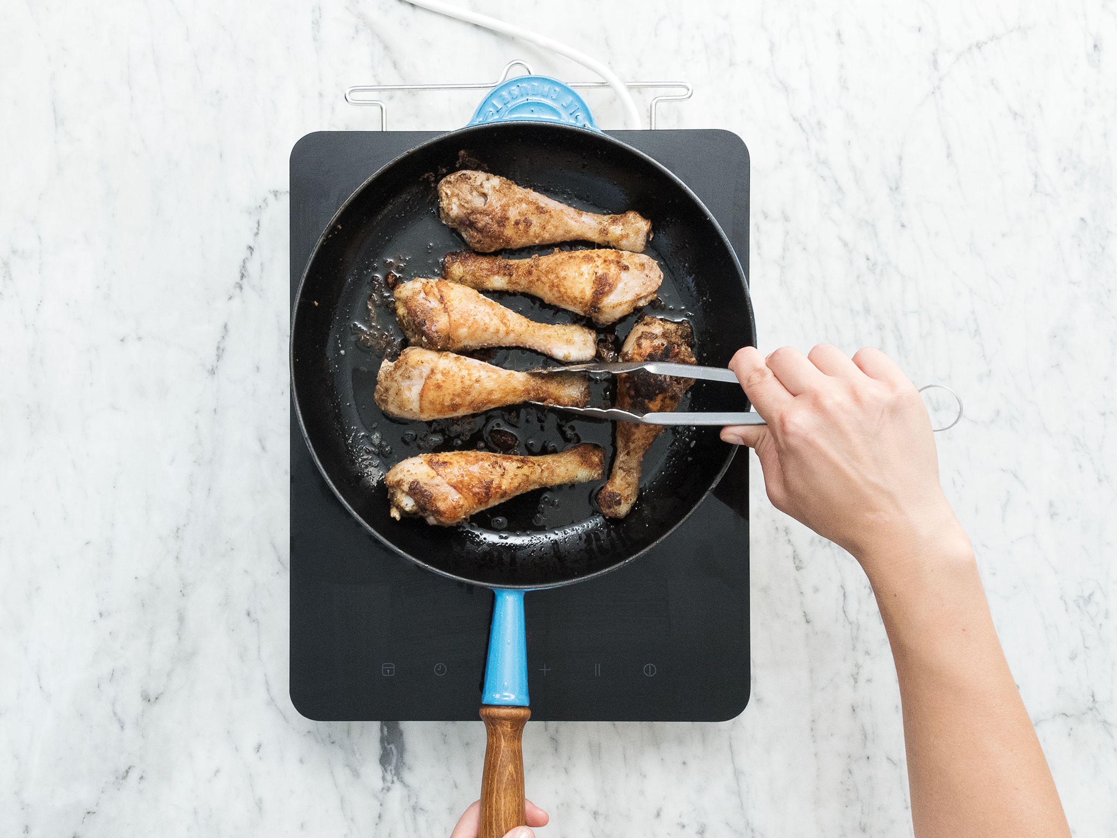 Remove chicken legs from marinade and toss in starch until covered. Heat oil in a frying pan and fry chicken legs on high heat for approx. 6 – 8 min. until crispy. Remove and degrease on paper towels.