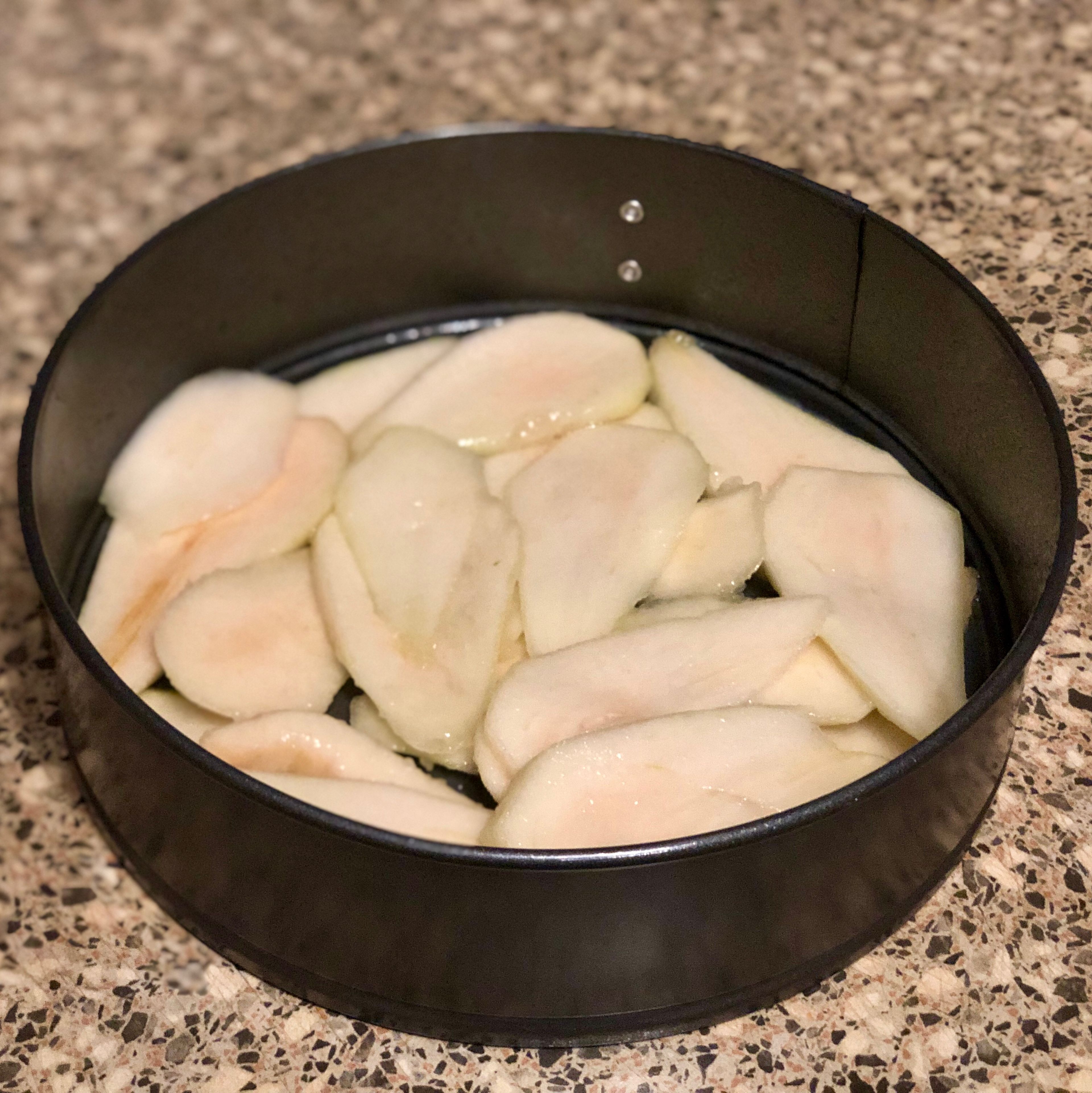 Arrange the pear slices on the bottom of the springform pan.