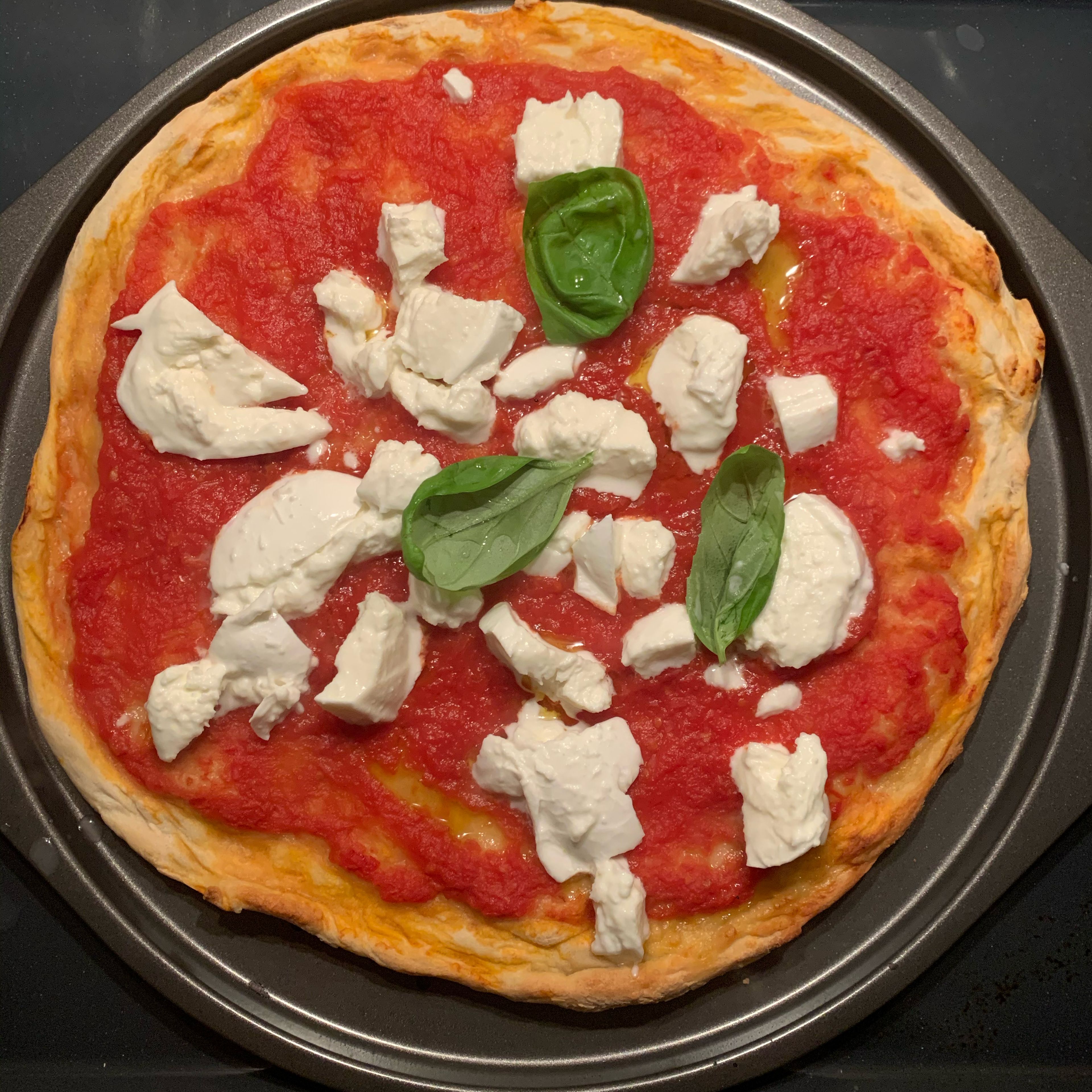 Add the sliced mozzarella cheese and a few basil leaves. Bake for 5 minutes until the mozzarella is fully cooked.