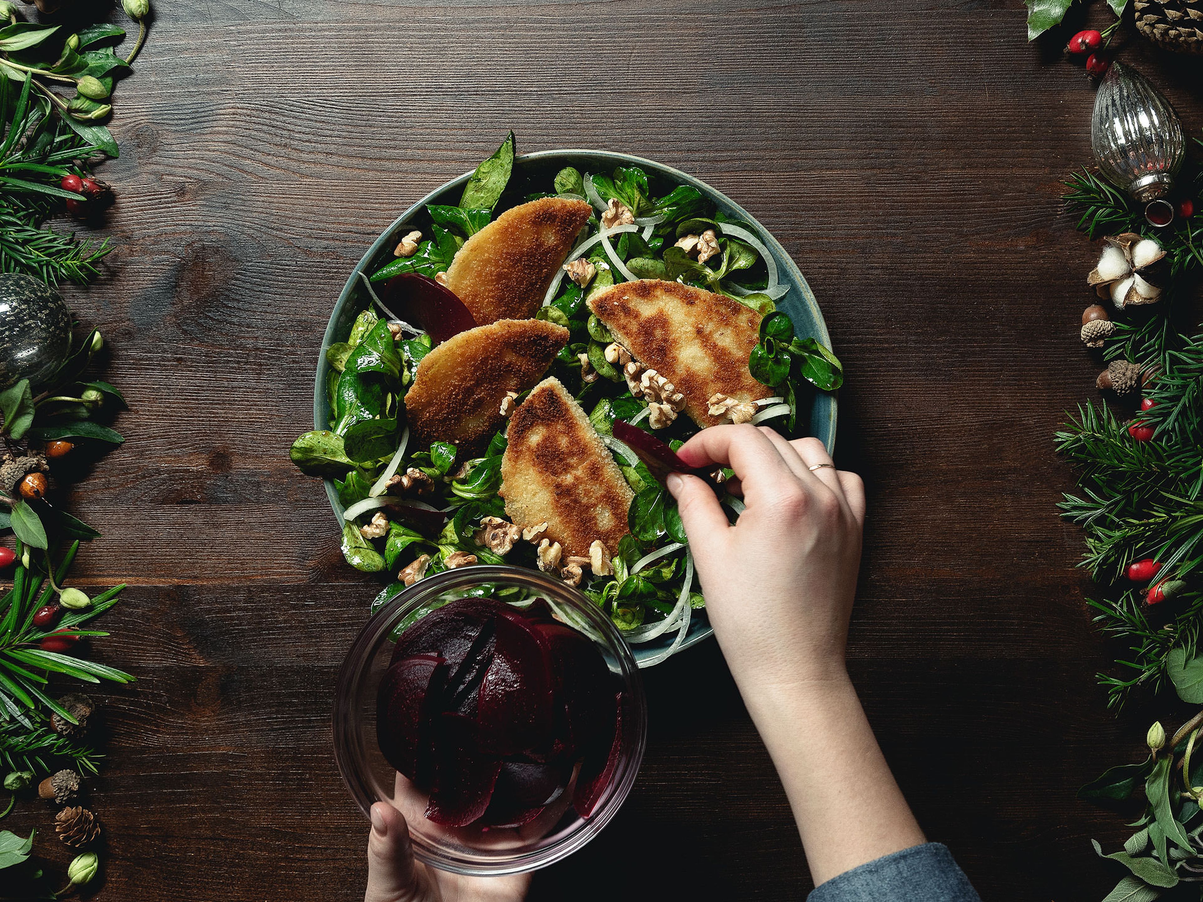 In a large bowl whisk together the balsamic vinegar, pumpkin seed oil, and honey and season with salt and pepper. Add lamb’s lettuce, toss to combine, and transfer to a serving plate. Arrange onion, fried cheese pockets, walnuts, and beets over the salad. Serve immediately and enjoy!