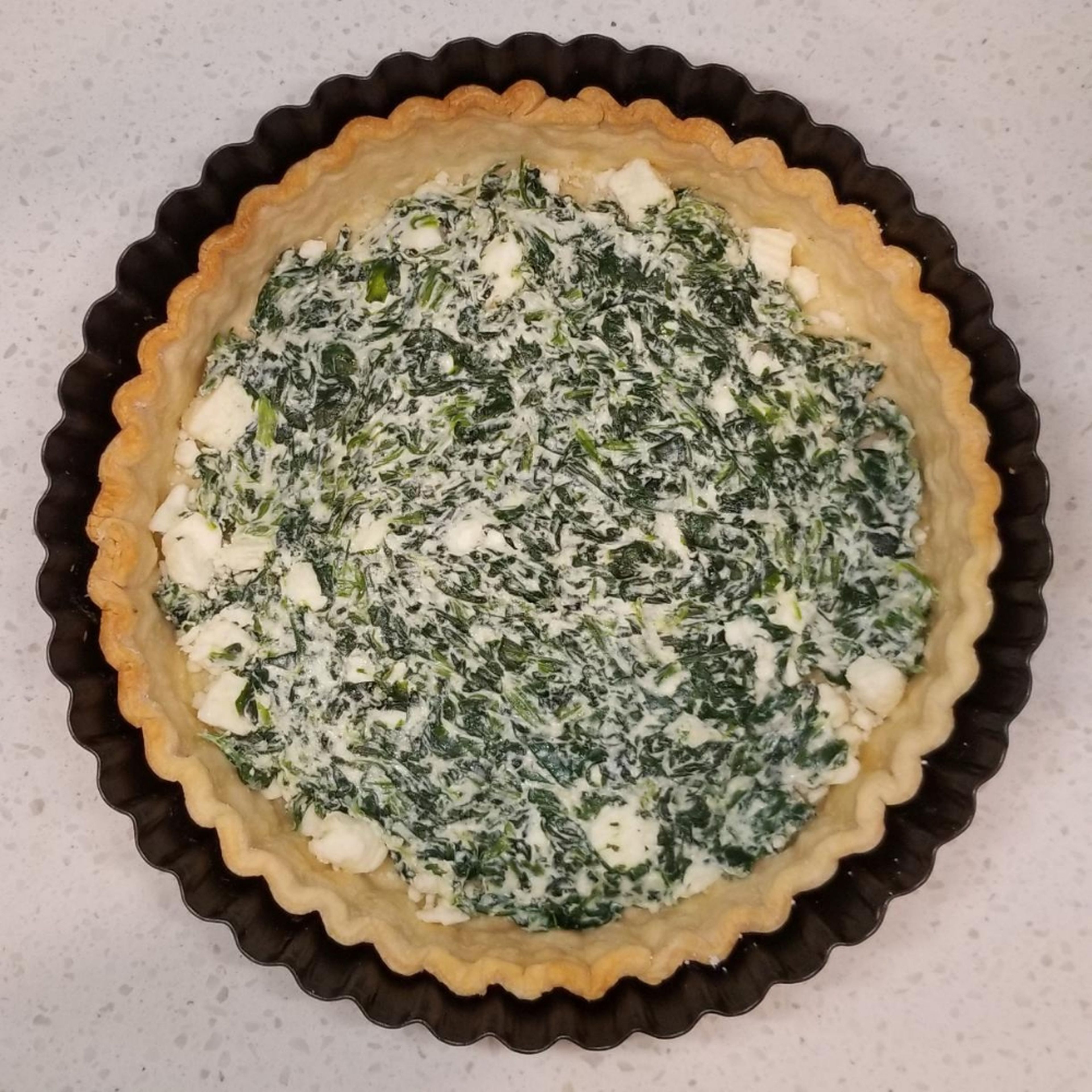 Spread spinach-cheese mixture along bottom of crust. Be sure to keep feta randomly dispersed below.