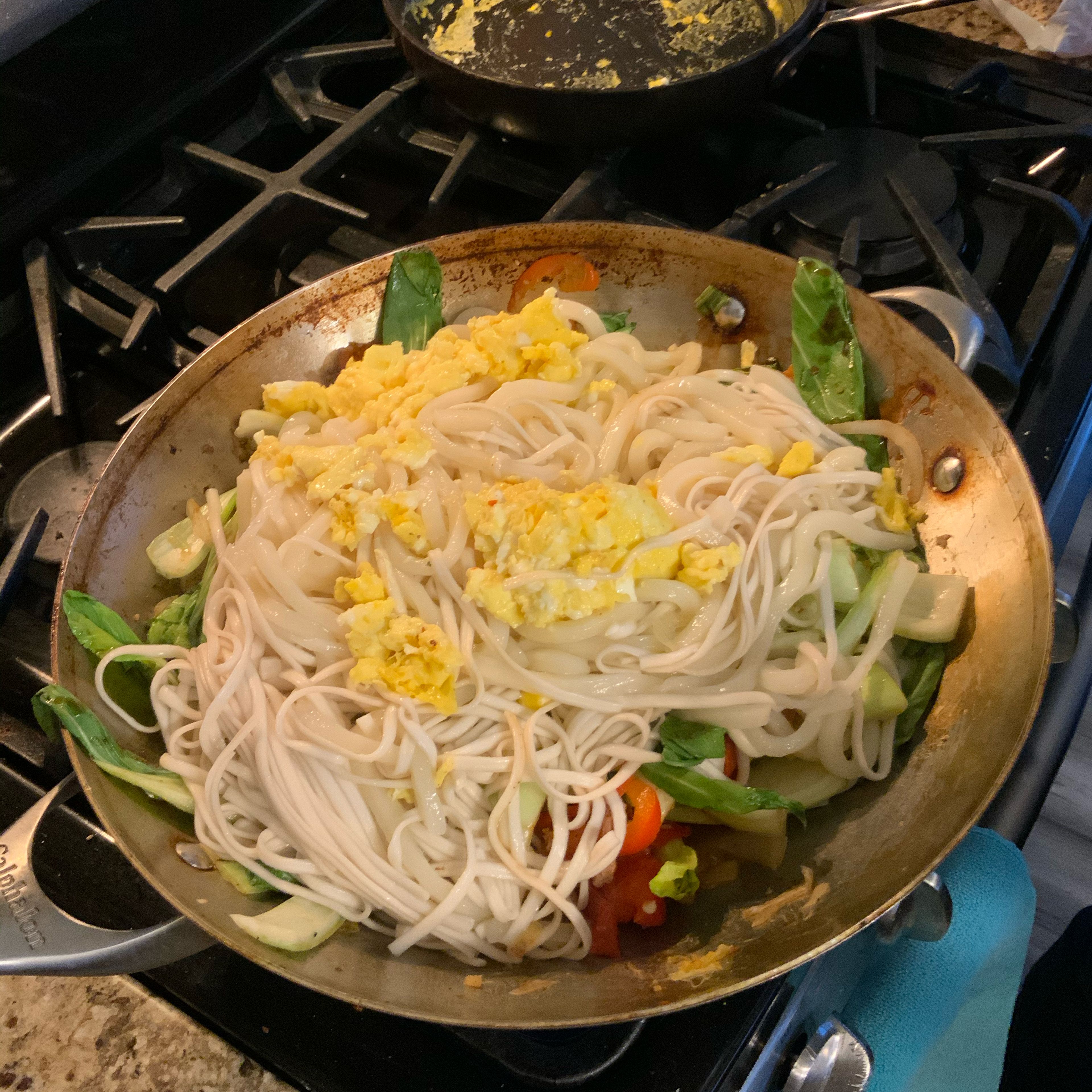 Drain the noodles and add noodles and eggs to the wok. Salt to preference.