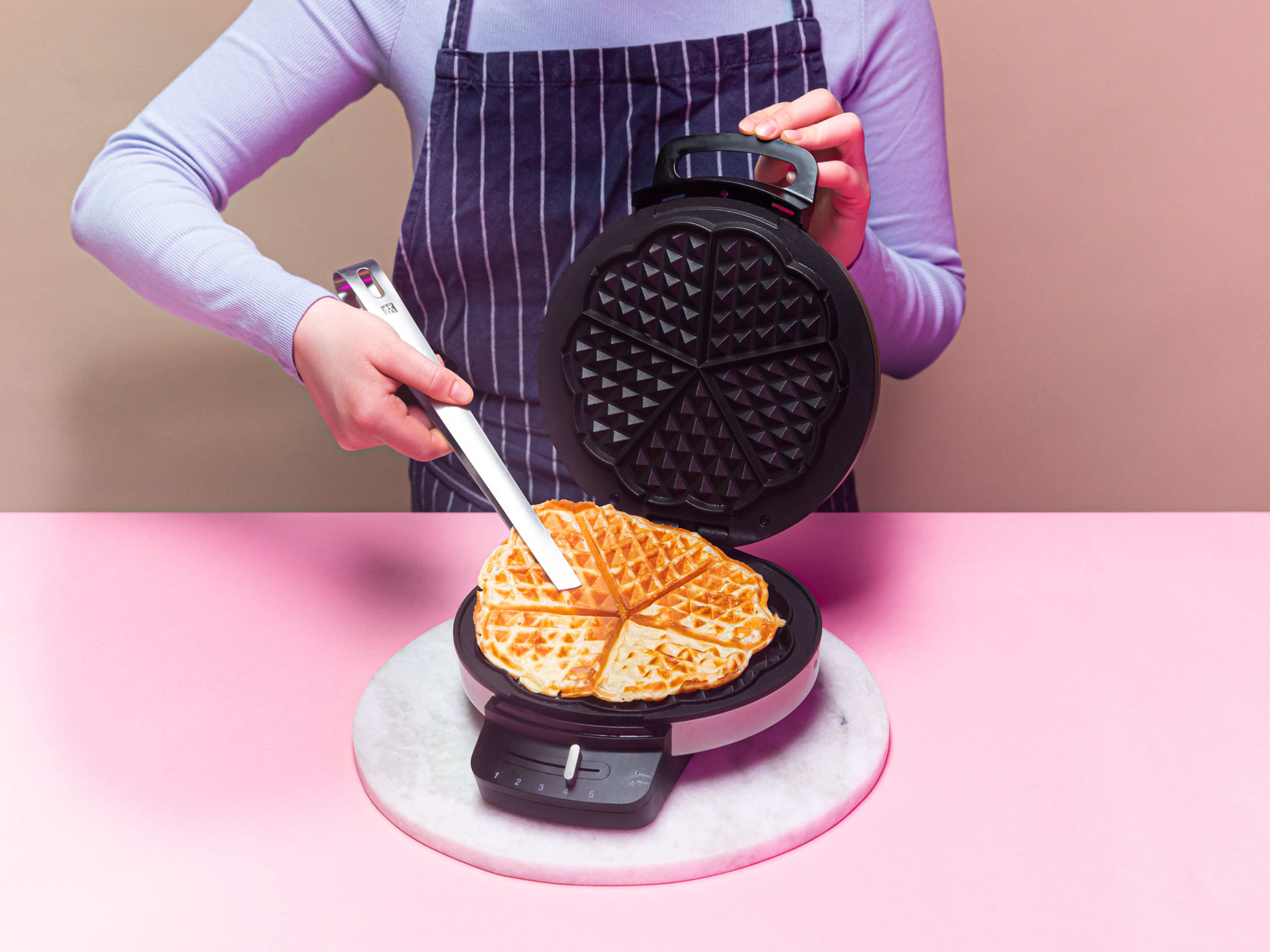 Preheat a waffle iron and lightly grease with melted butter. Fill waffle iron with batter and cook waffle until golden brown, approx. 5 min. Repeat with all the batter and transfer waffles to preheated oven to keep warm.