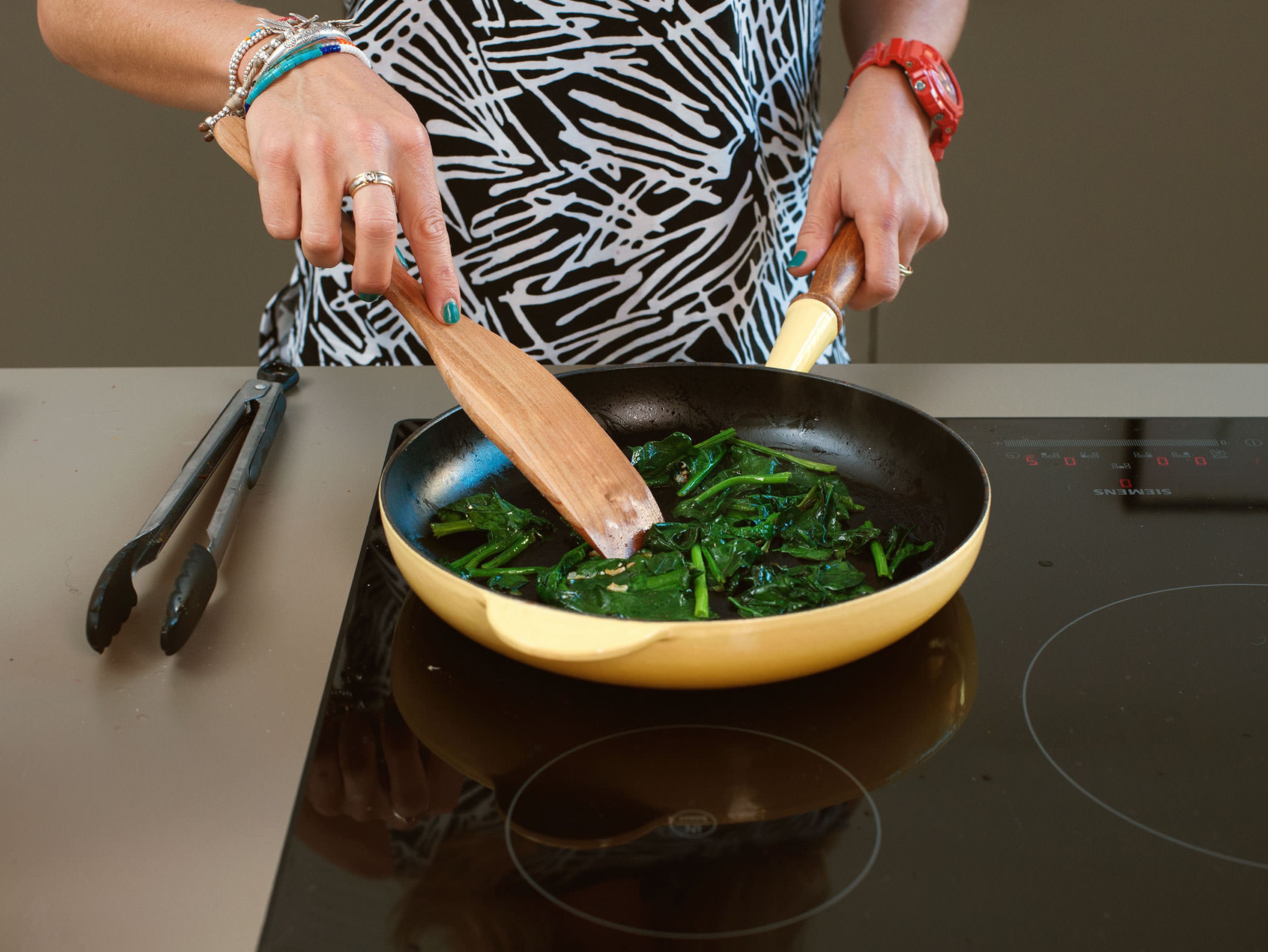 Add some of the coconut oil to pan, sauté garlic, and wilt spinach over medium heat for approx. 1 – 2 min. Drizzle with part of the lemon juice. Add toasted pine nuts to spinach and set aside.