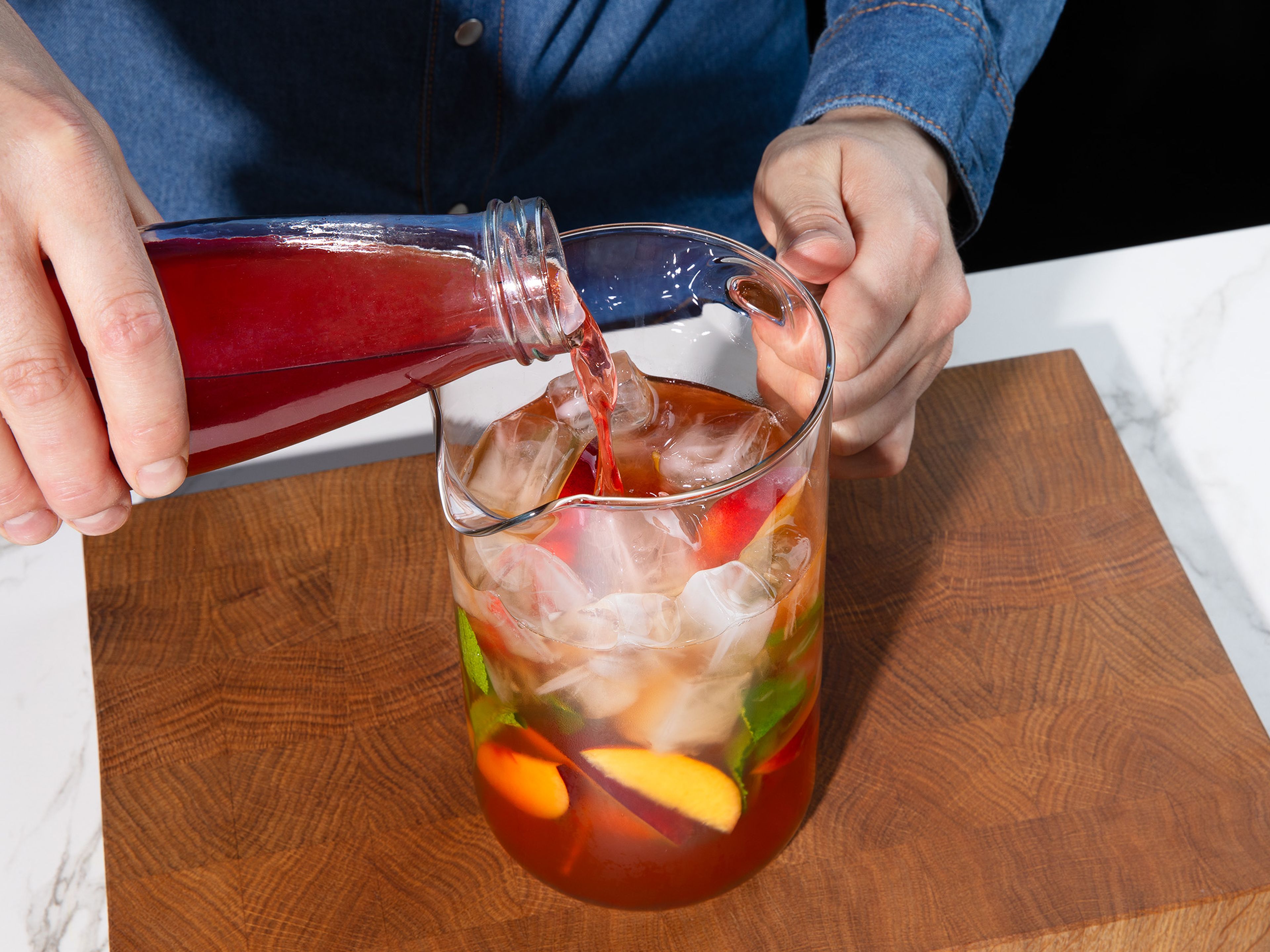 Prepare a large pitcher with ice, more mint sprigs, and remaining sliced peach. Pour in iced water, followed by the cooled tea, peach syrup, and lemon juice. Stir well. Pour into glasses and enjoy!