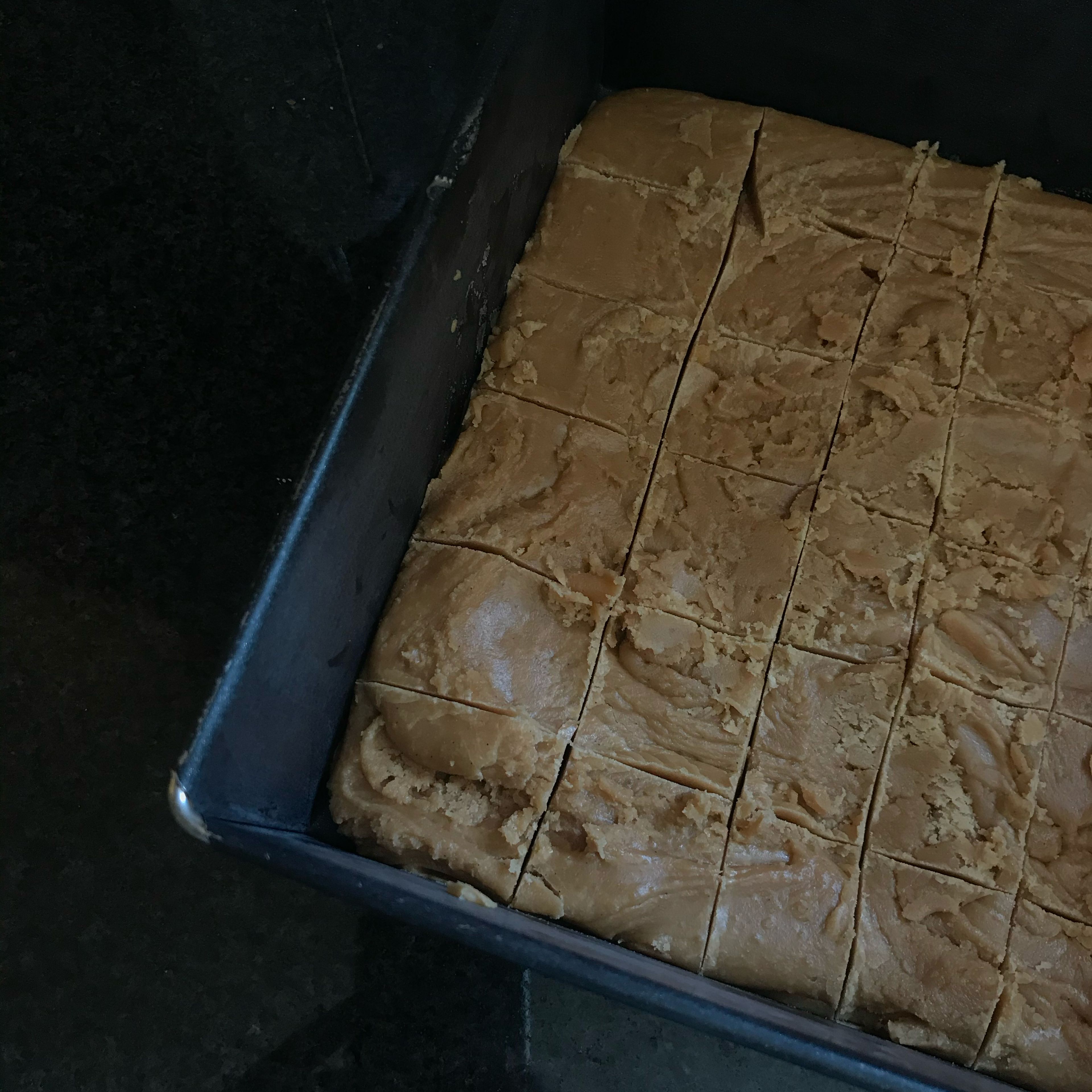 Pour the fudge into a square or circular cake tin or small baking tray. Smooth out with a knife and then after 10 mins, score into square/pieces with a knife so it is easy to break when it has set fully.