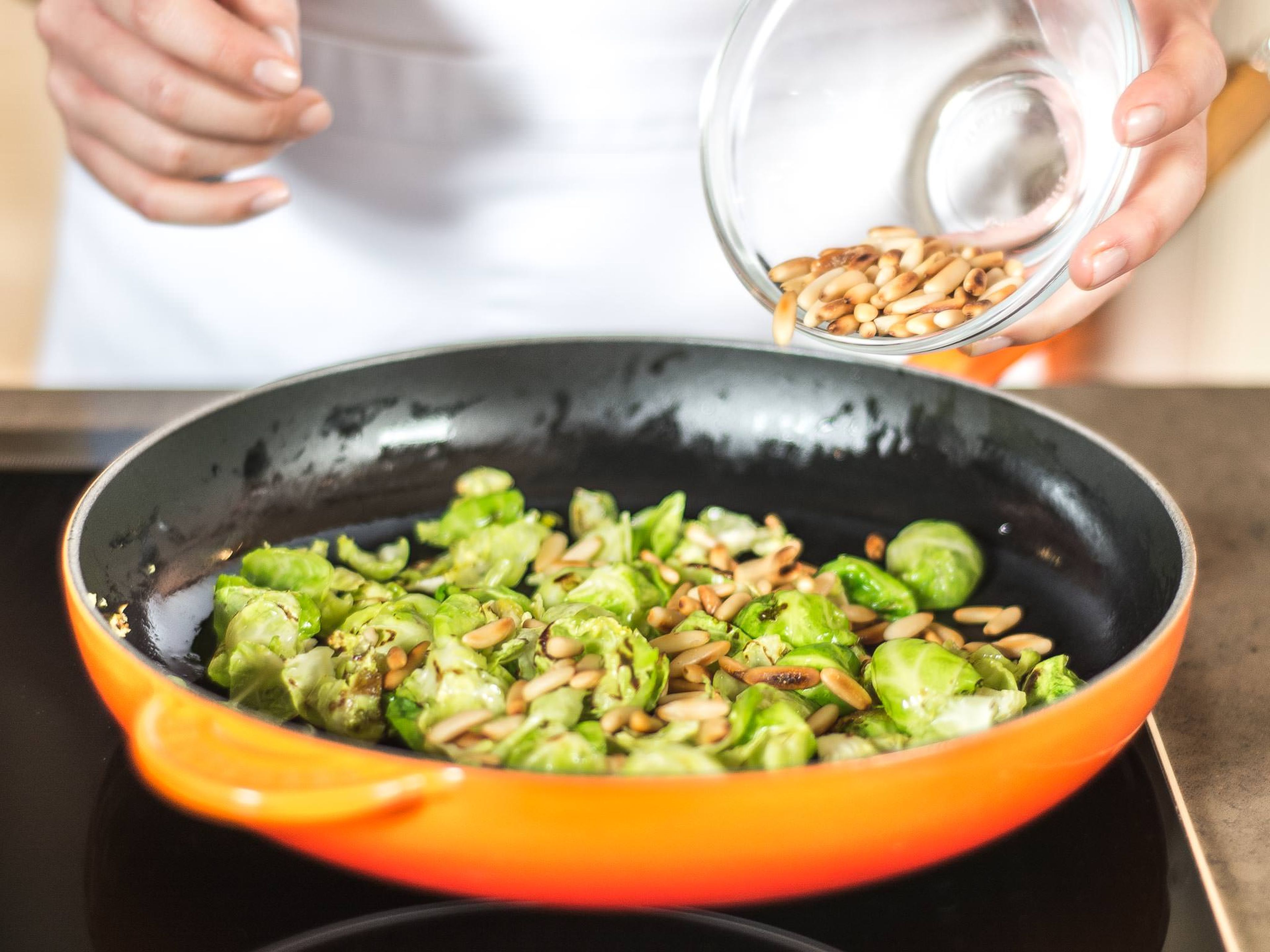 As soon as Brussels sprout leaves have slightly softened (after approx. 2 - 3 min.) add the pine nuts and roast for an additional 1 – 2 min.