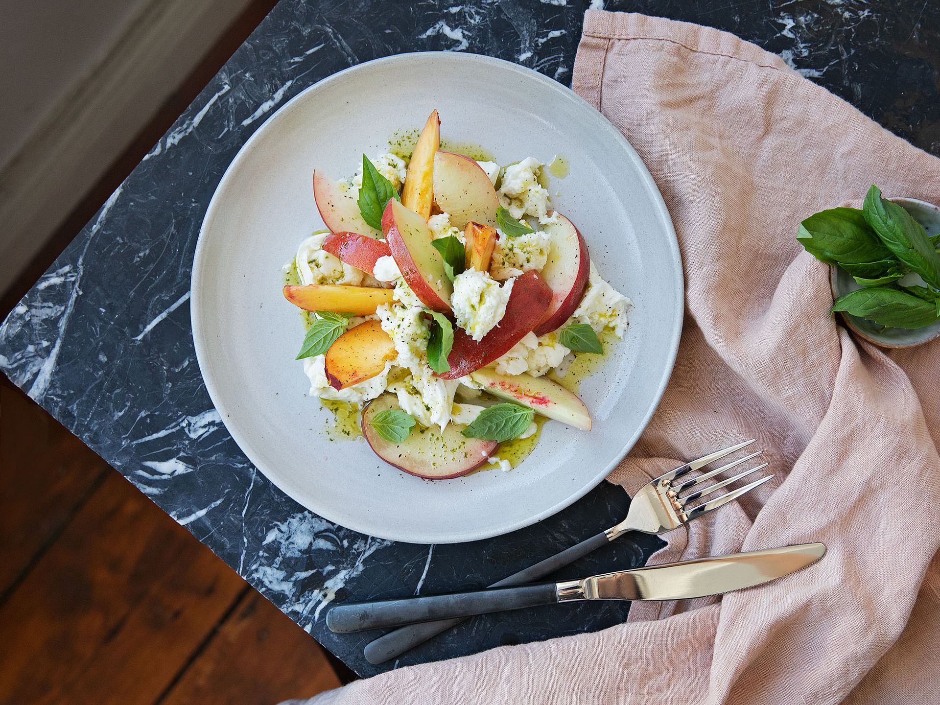 Peach Caprese salad with basil oil
