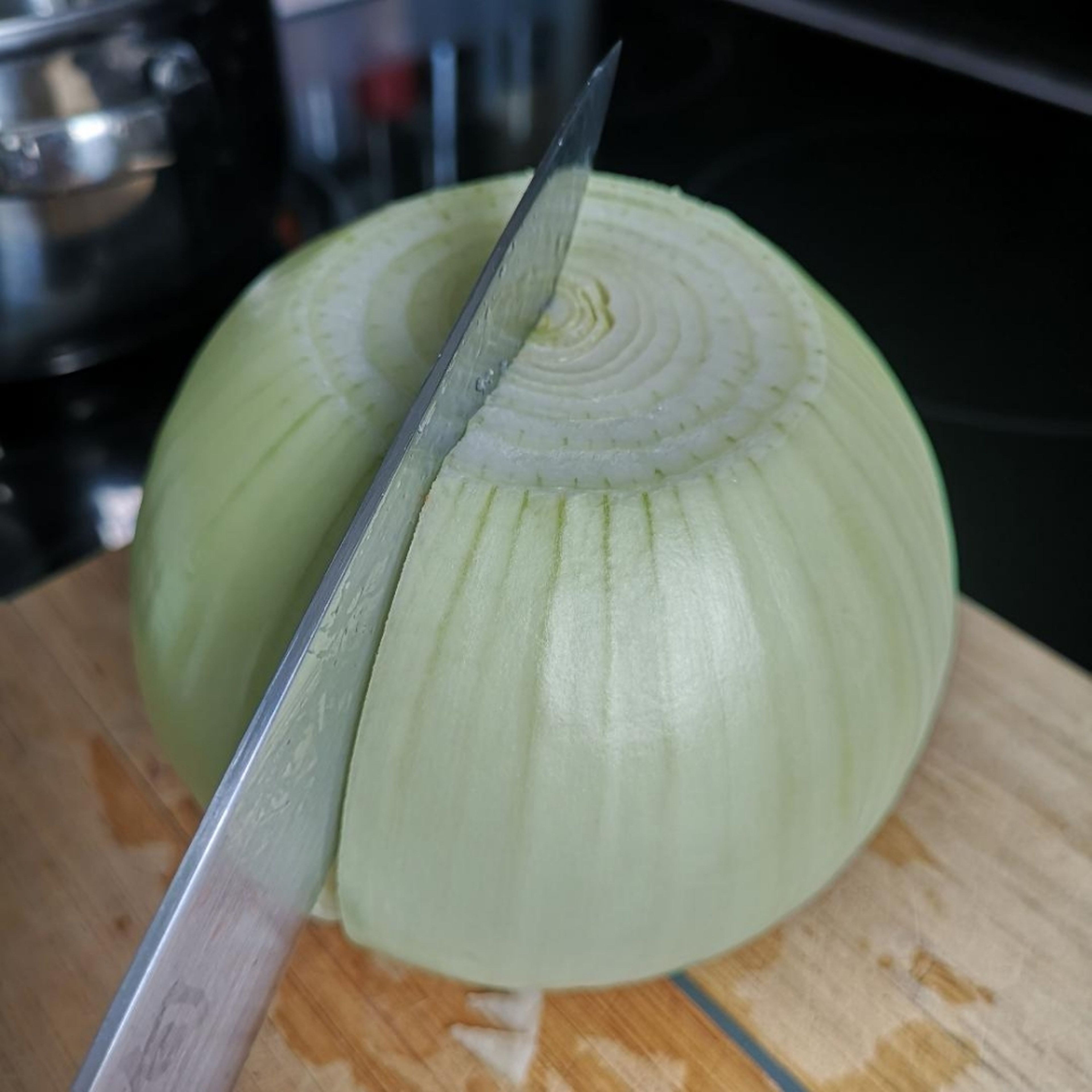 make a cut on the onion only cutting half way through just Like in the picture. make sure you peel off any hard skin.