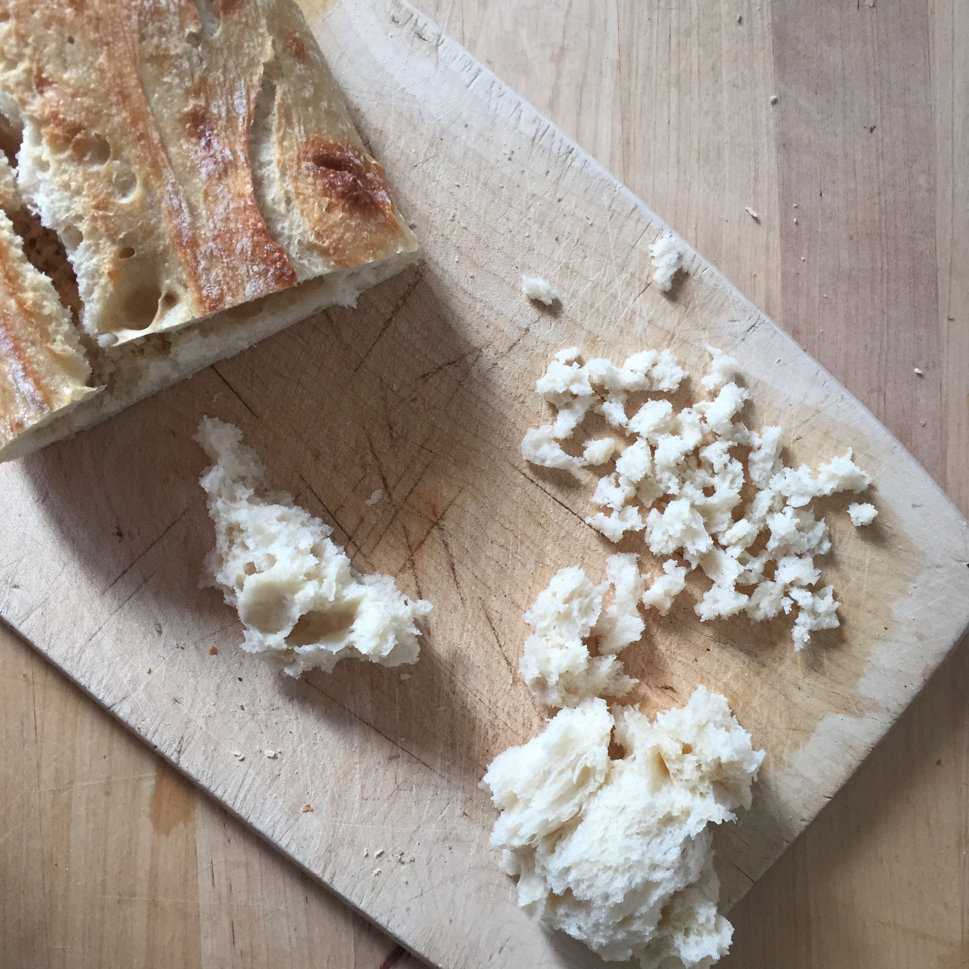 Remove the soft inside of the ciabatta bread and crumble it. Toast with 2 tbsp olive oil, a crushed garlic clove, and salt until golden brown. Let cool down.