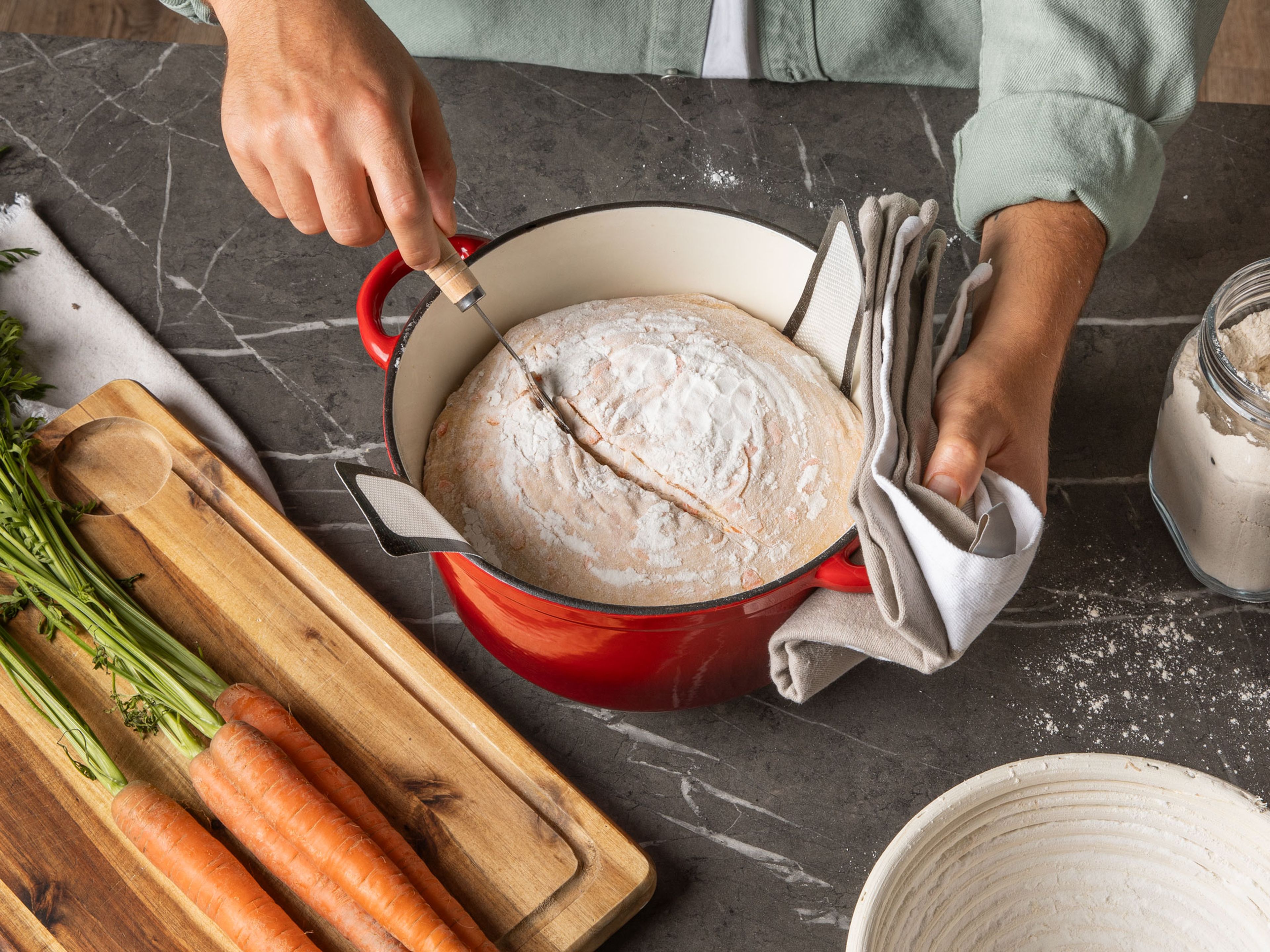 Place a Dutch oven with lid in the oven and preheat to 250°C/480°F. Once preheated, gently flip the dough into the Dutch oven using a sling. Score the top with a sharp knife, put the Dutch oven lid back on and transfer to the middle rack of the oven. Allow to bake for 30 min. Then, reduce the temperature to 220°C/430°F, remove the lid to allow the bread to bake for another 15 min. until the top is crunchy and golden brown. Remove from the oven and allow to cool.