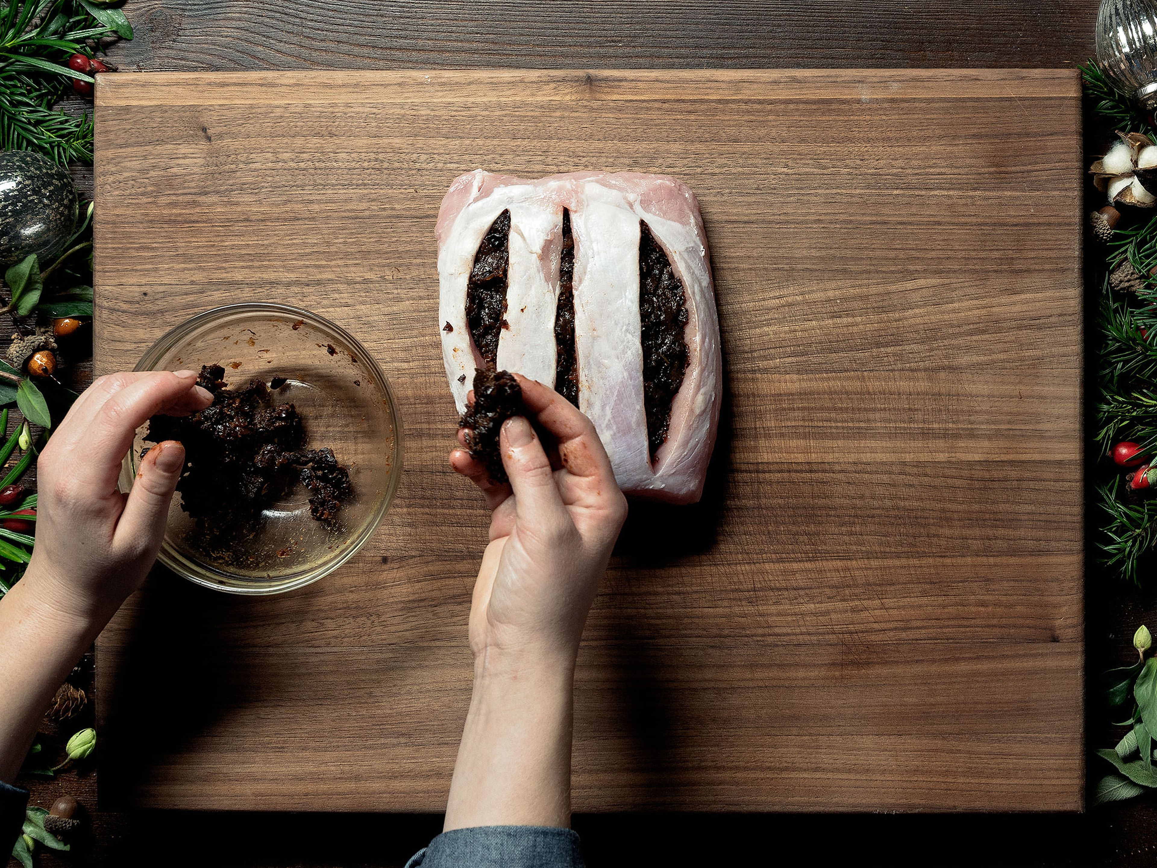 Preheat the oven to 160°C/325°C. Mince the prunes and mix with ground ginger, ground cloves, and ground cinnamon in a food processor. Cut three pockets lengthwise into the pork roast, making sure not to cut all the way through, and fill each pocket with the prune filling.