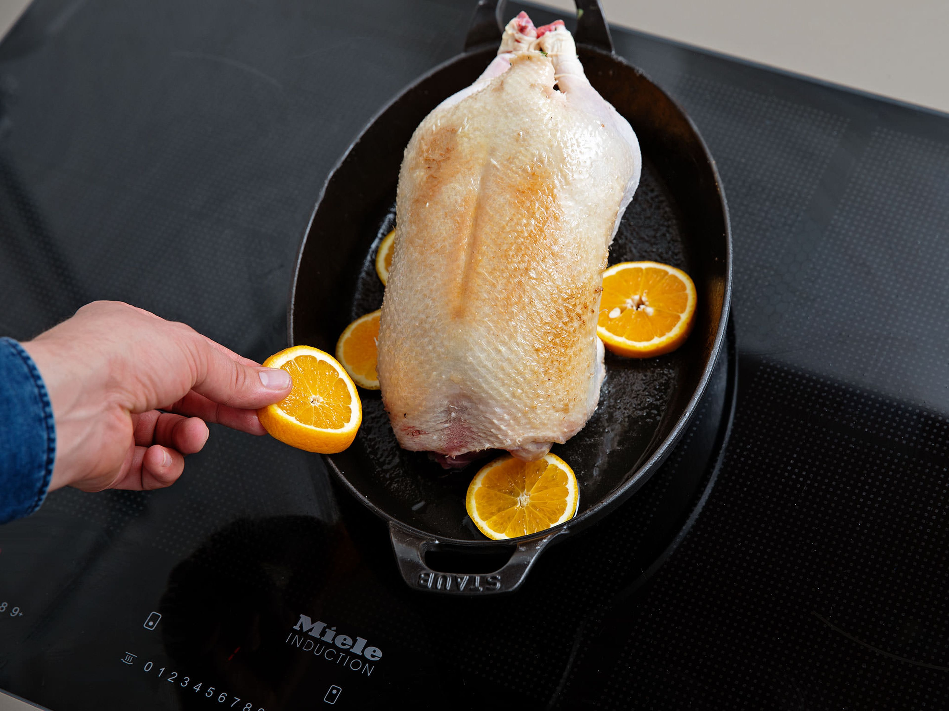 Fry in the roasting pan until golden on both sides. Slice another orange. Remove the duck from the roasting pan, add orange slices and put the duck back in the pan. Transfer to the oven and roast for approx. 1.5 hrs.