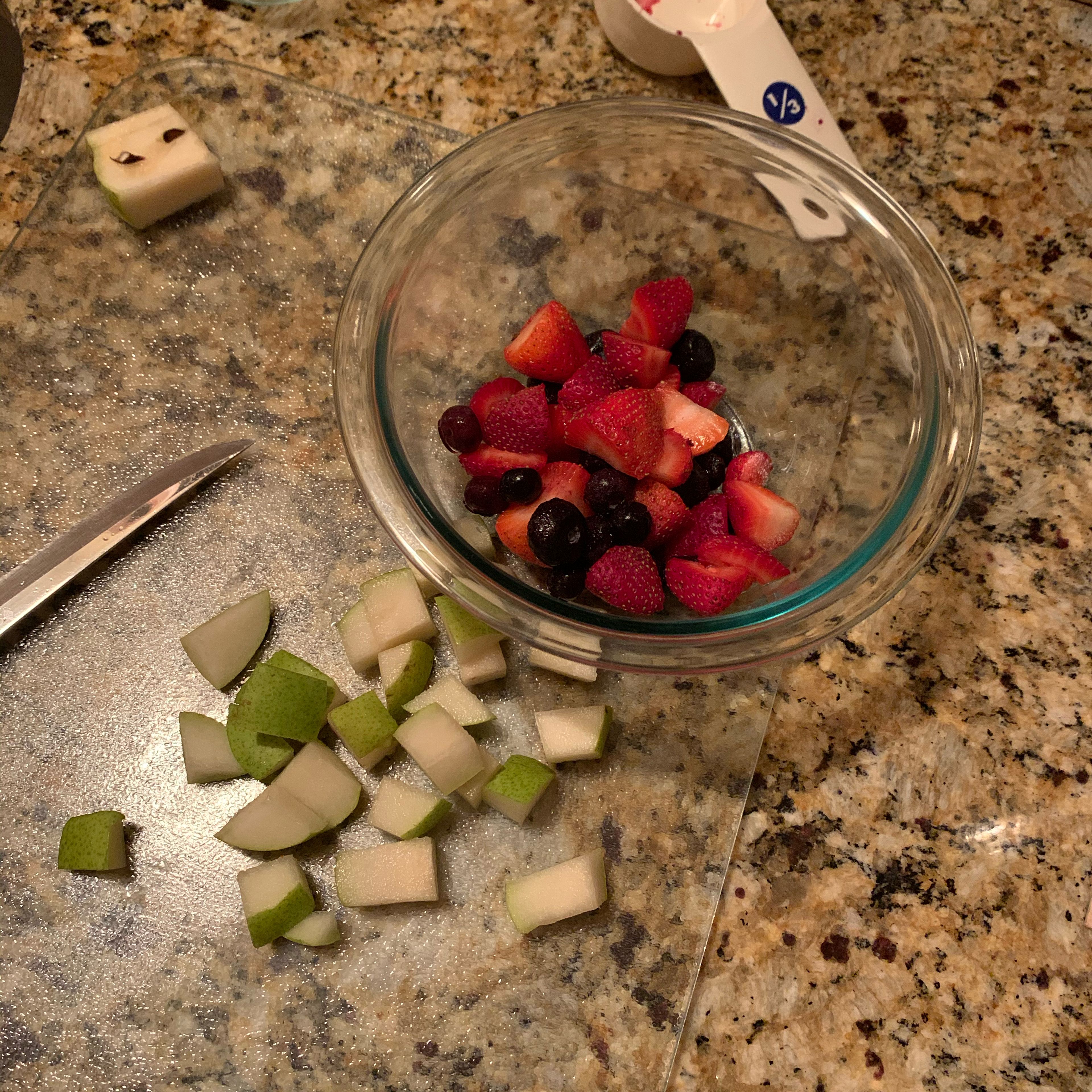Cut half of pear into cubes and add to fruit mixture.