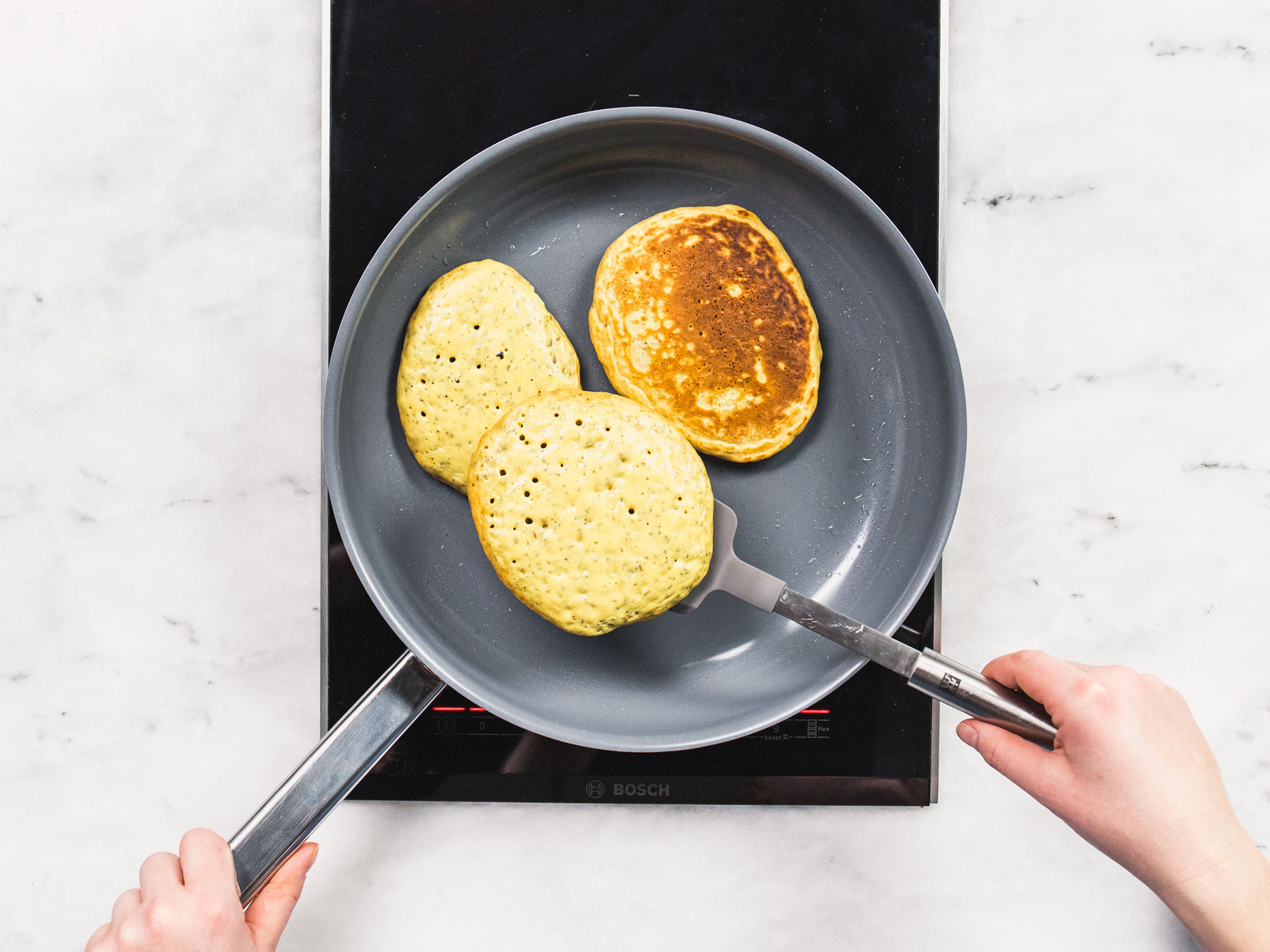 Add some vegetable oil to a pan over medium heat. Then add a few large spoonfuls of batter to make individual pancakes. When bubbles appear on the top of pancakes, flip them and let cook for another 2 min., or until cooked through. Repeat until no batter remains.
