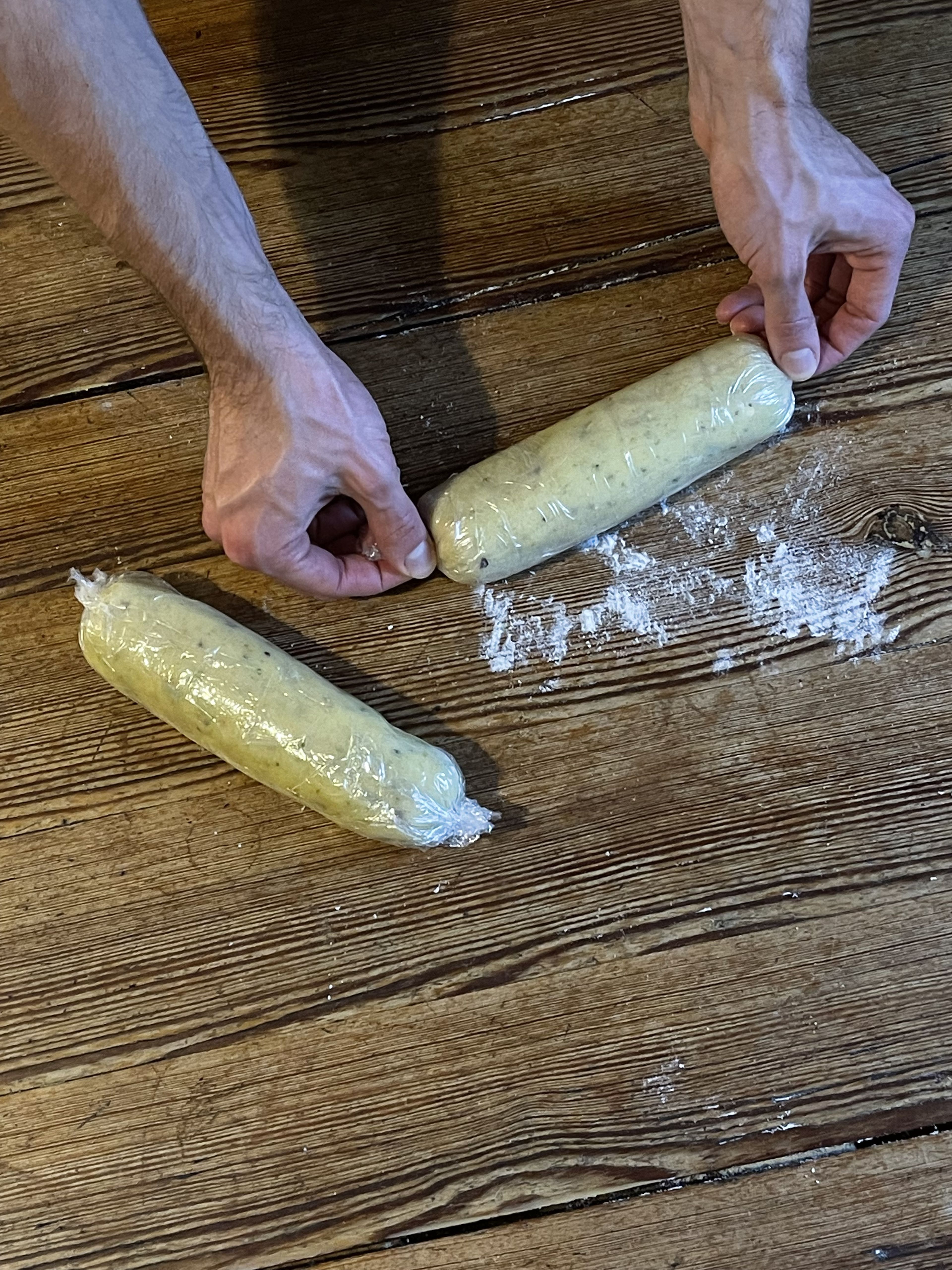 Remove the dough from the bowl. Knead with your hands until smooth. Now divide the dough in half and form it into two rolls with a diameter of approx. 4 cm. Wrap each dough roll in plastic wrap and let rest in the refrigerator for about 1 hr.
