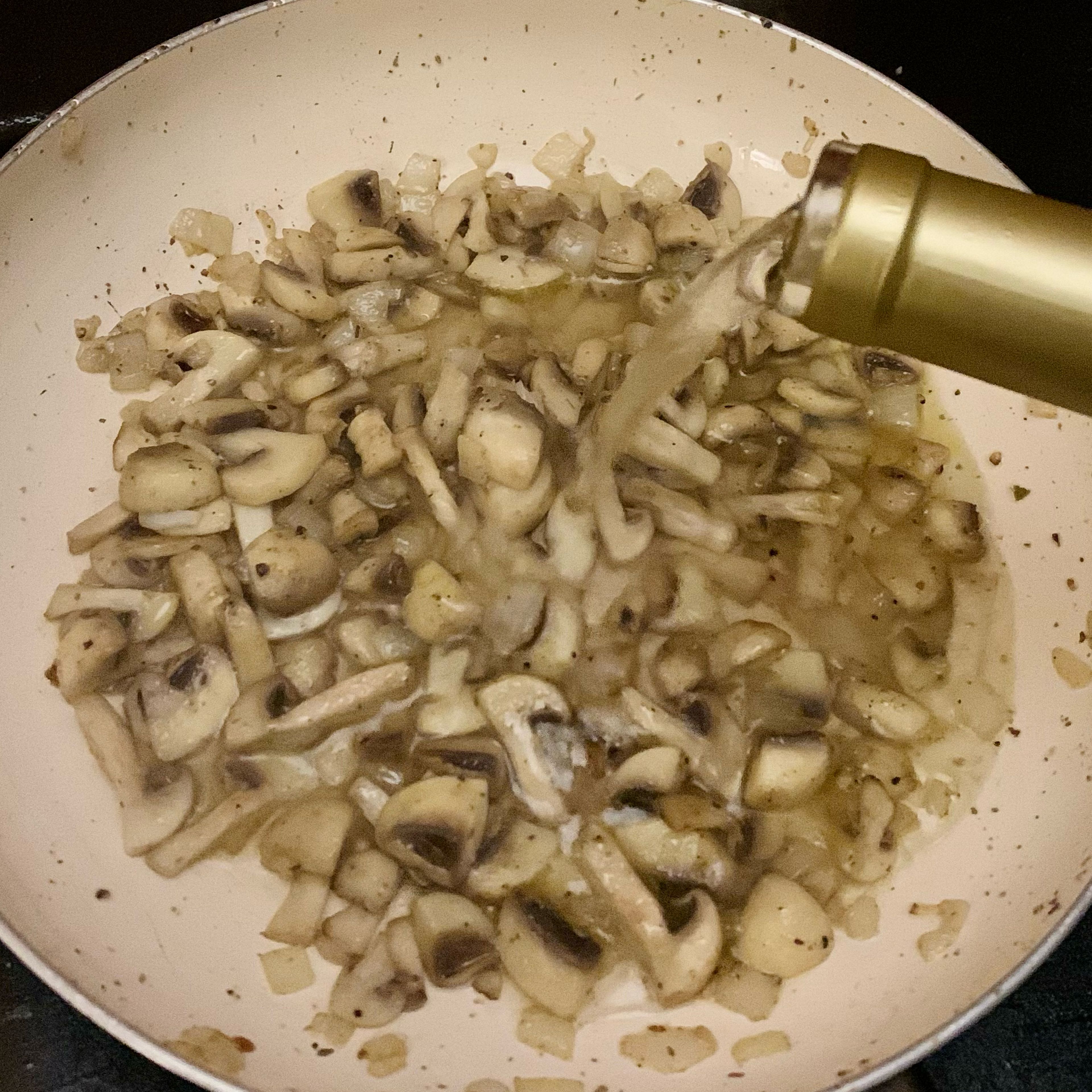 When the onion is smelling good and cooked, let’s add the mushrooms and stir till they’re half cooked, when we will add the wine and wait for it to evaporate the alcohol. 