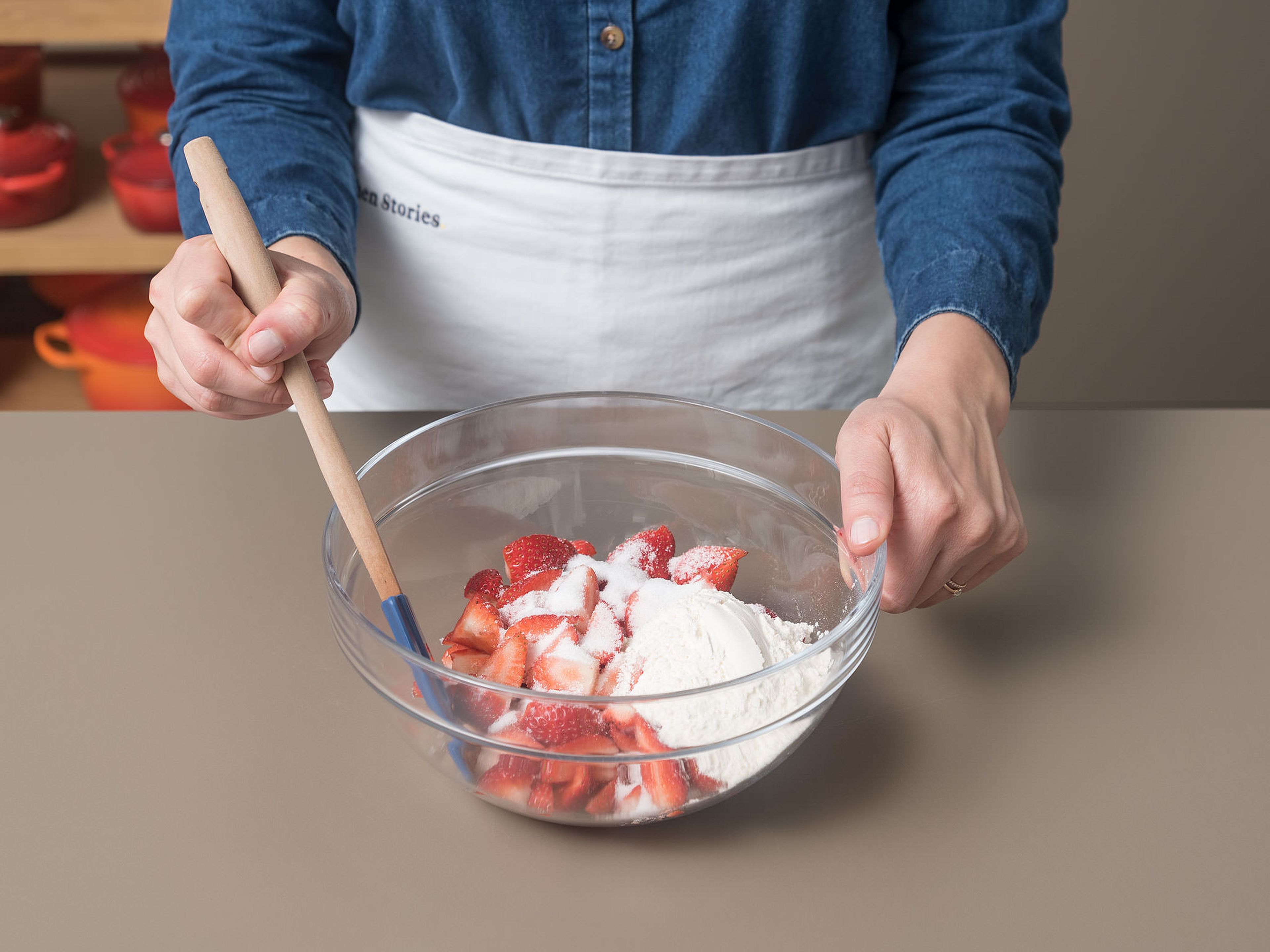 Für die Erdbeerschicht Erdbeeren grob schneiden. Erdbeeren, Zucker und Mehl in einer großen Schüssel vermengen und beiseitestellen.