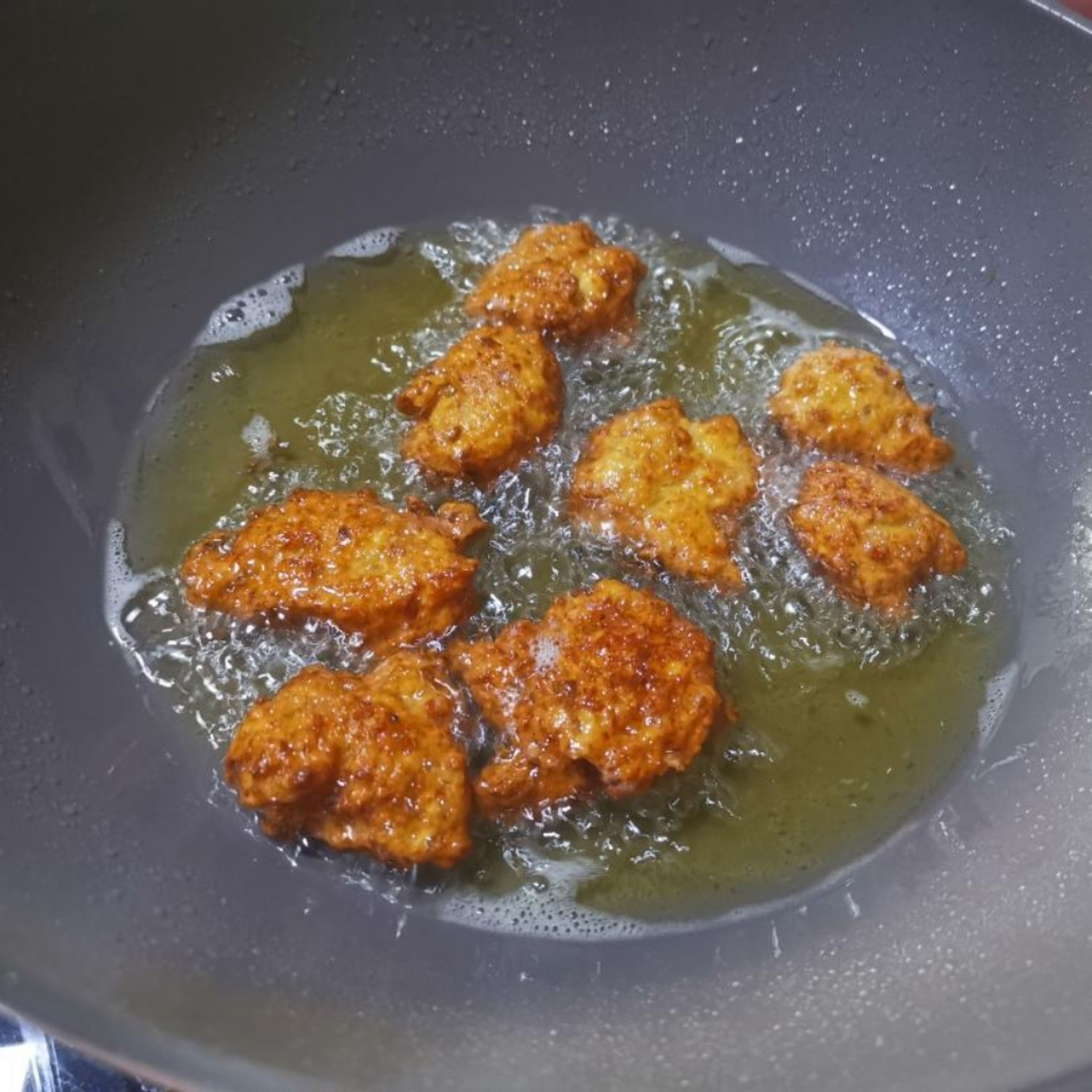 10. Scoop out the fried meat balls and place in plaid laid with kitchen towel to drain off excess oil.